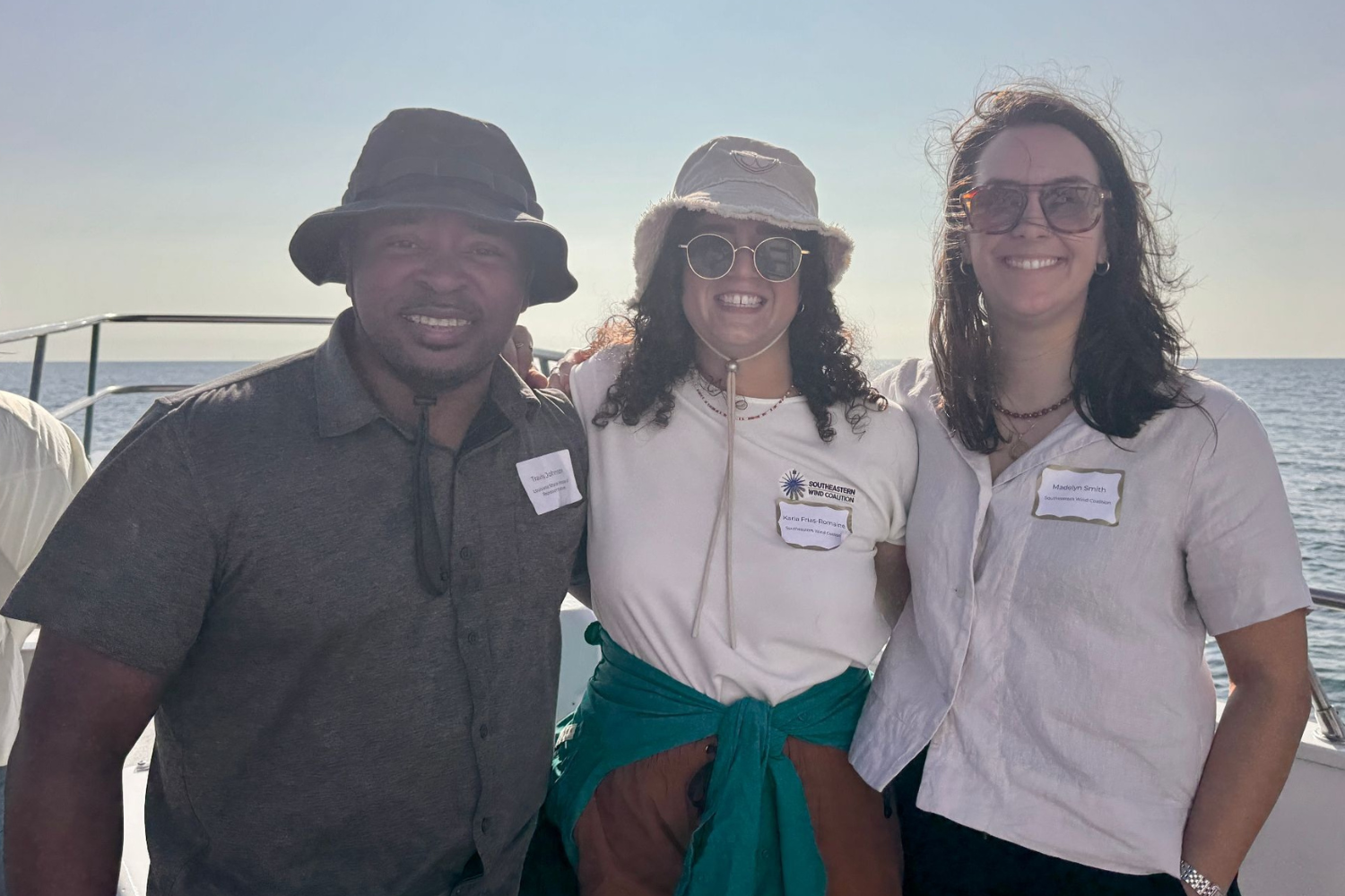 Three people posing on a boat deck