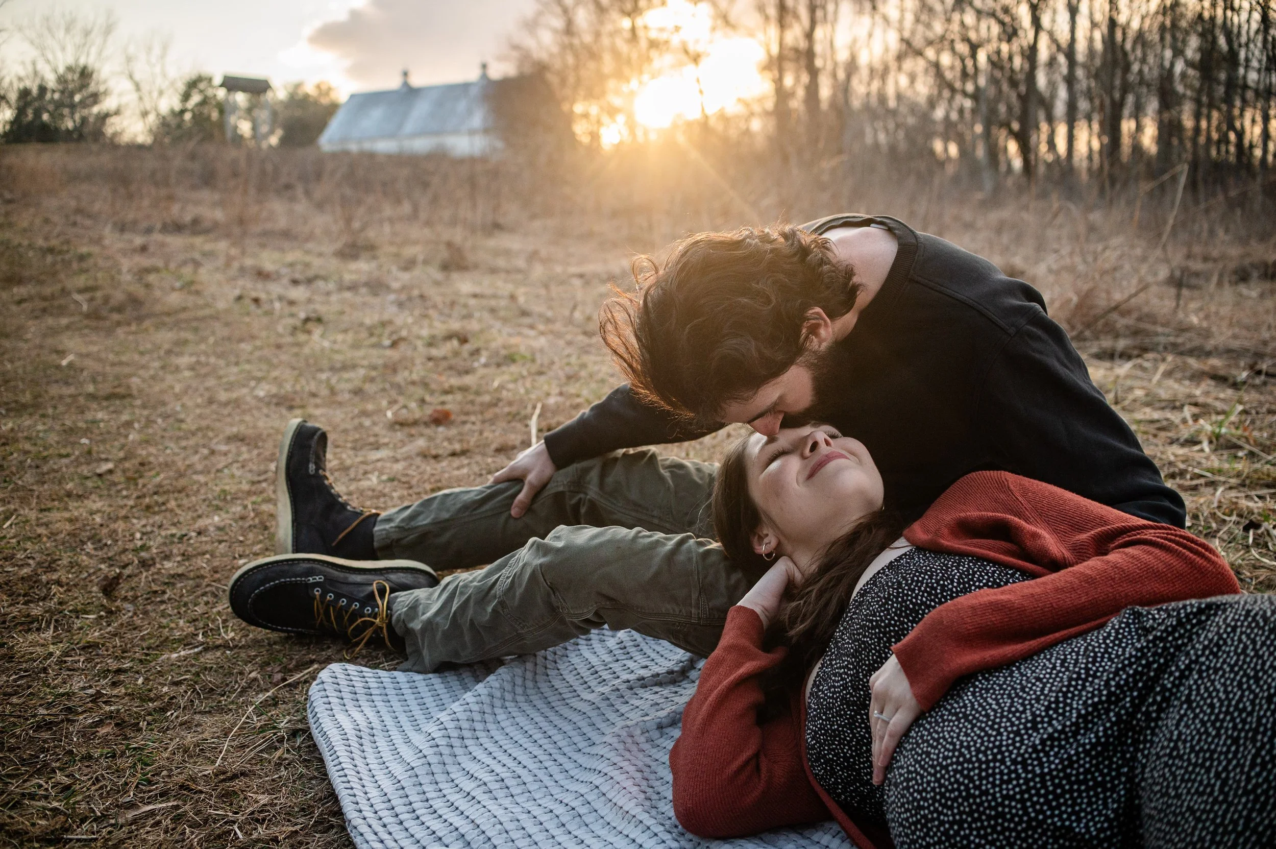 erin-e-gallagher-photography-Richmond-man-kissing-pregnant-wife-sunset-lying-down-maternity.jpg