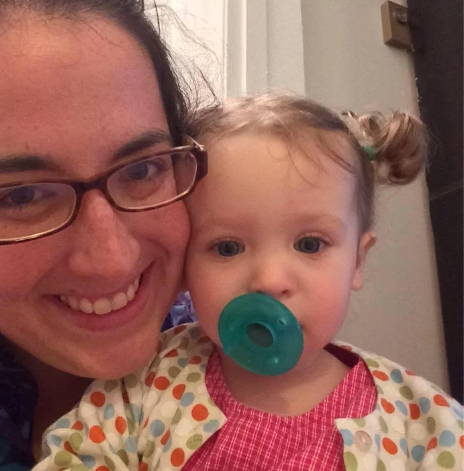 mom and toddler smile at camera in a selfie