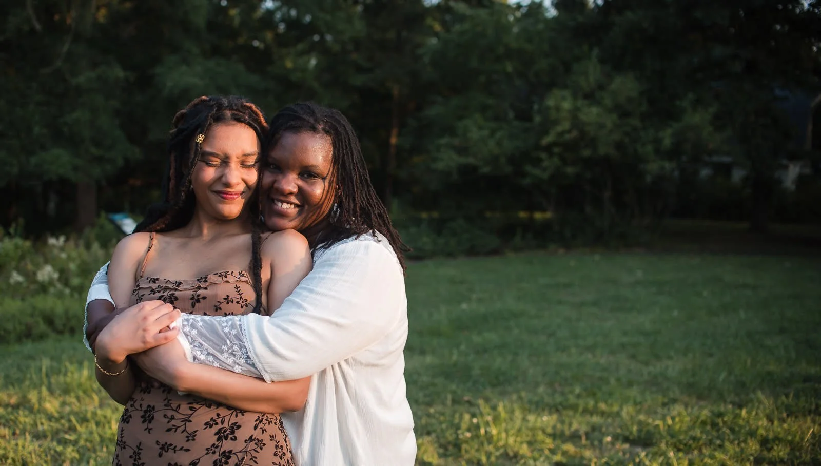mother and senior daughter embrace during a summer sunset family session at Ivy Creek Natural Area in Charlottesville, VA by Erin E Gallagher Photography