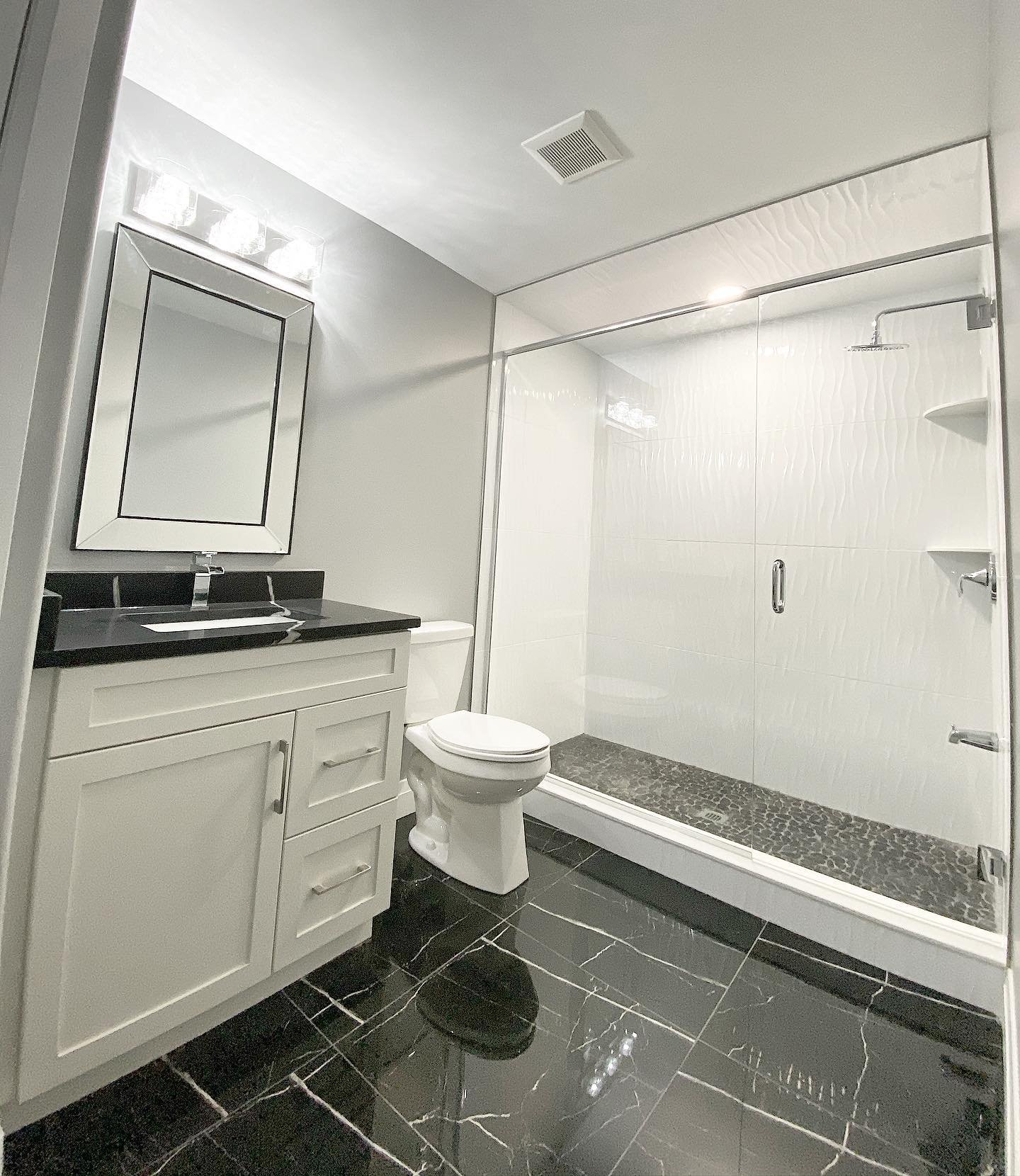 Floor to ceiling shower tiling with matching black on black stone top vanity and floors.
.
.
.
.
.
.
.
.
#homes #sleimanhomes #luxuryhome #qualityhomes #quality #windsorontario #ontario #construction #windsorhomes #tecumsehontario #kitchen #bathroom