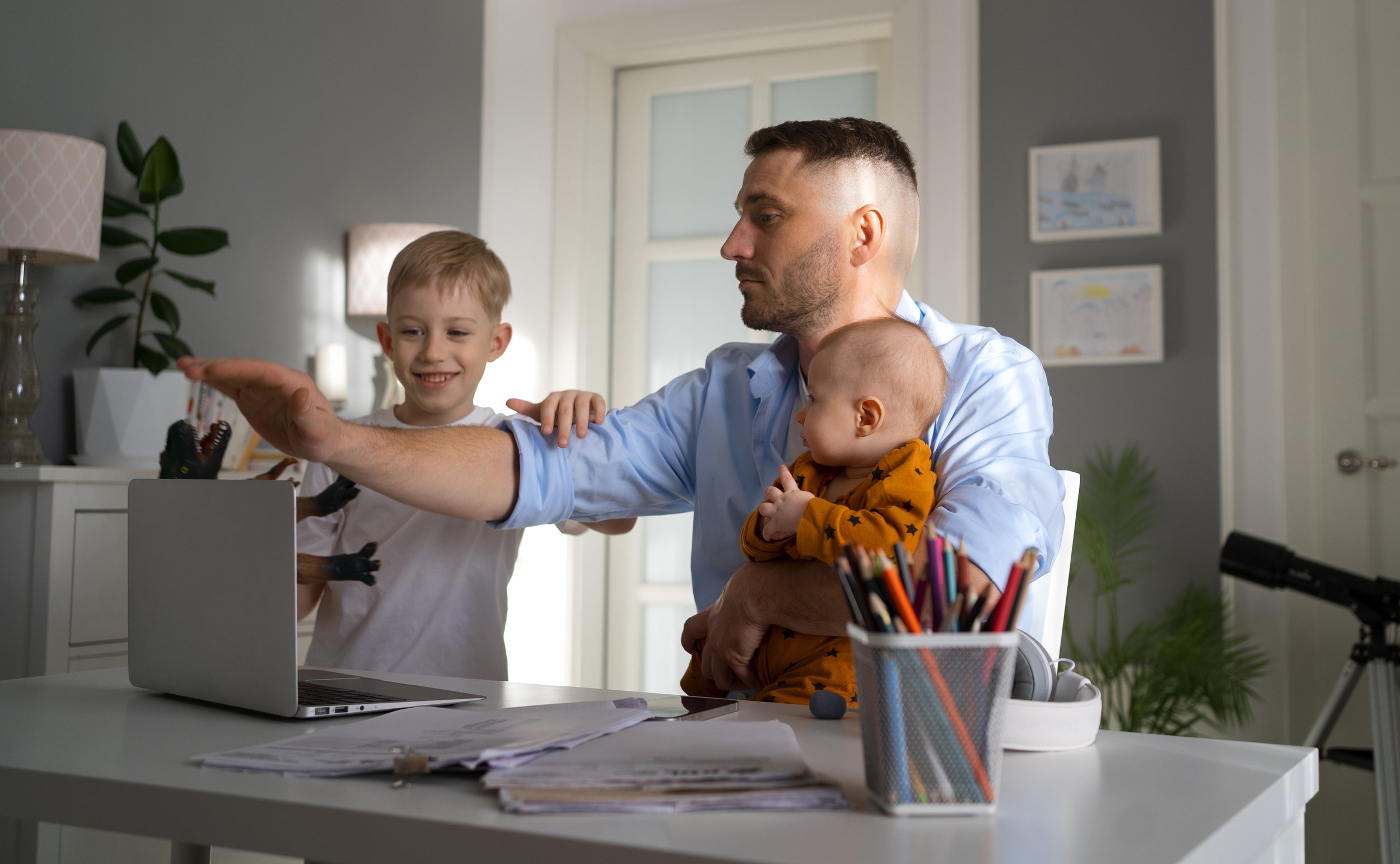 A father balancing parenting and working.