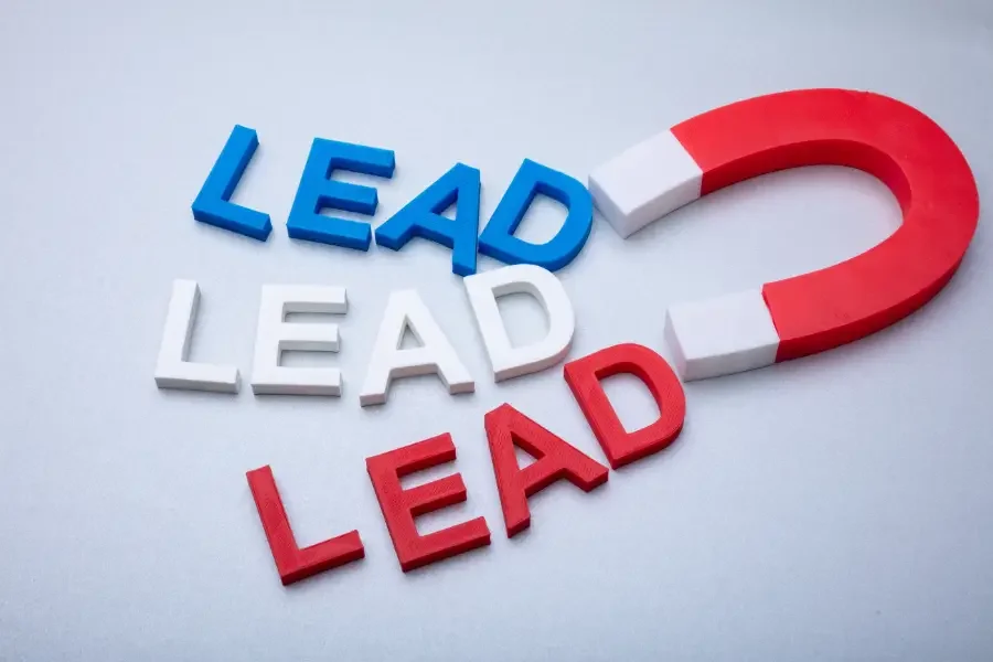 Colorful letters spelling 'LEAD' with a magnet, symbolizing attraction and lead generation in marketing strategies.