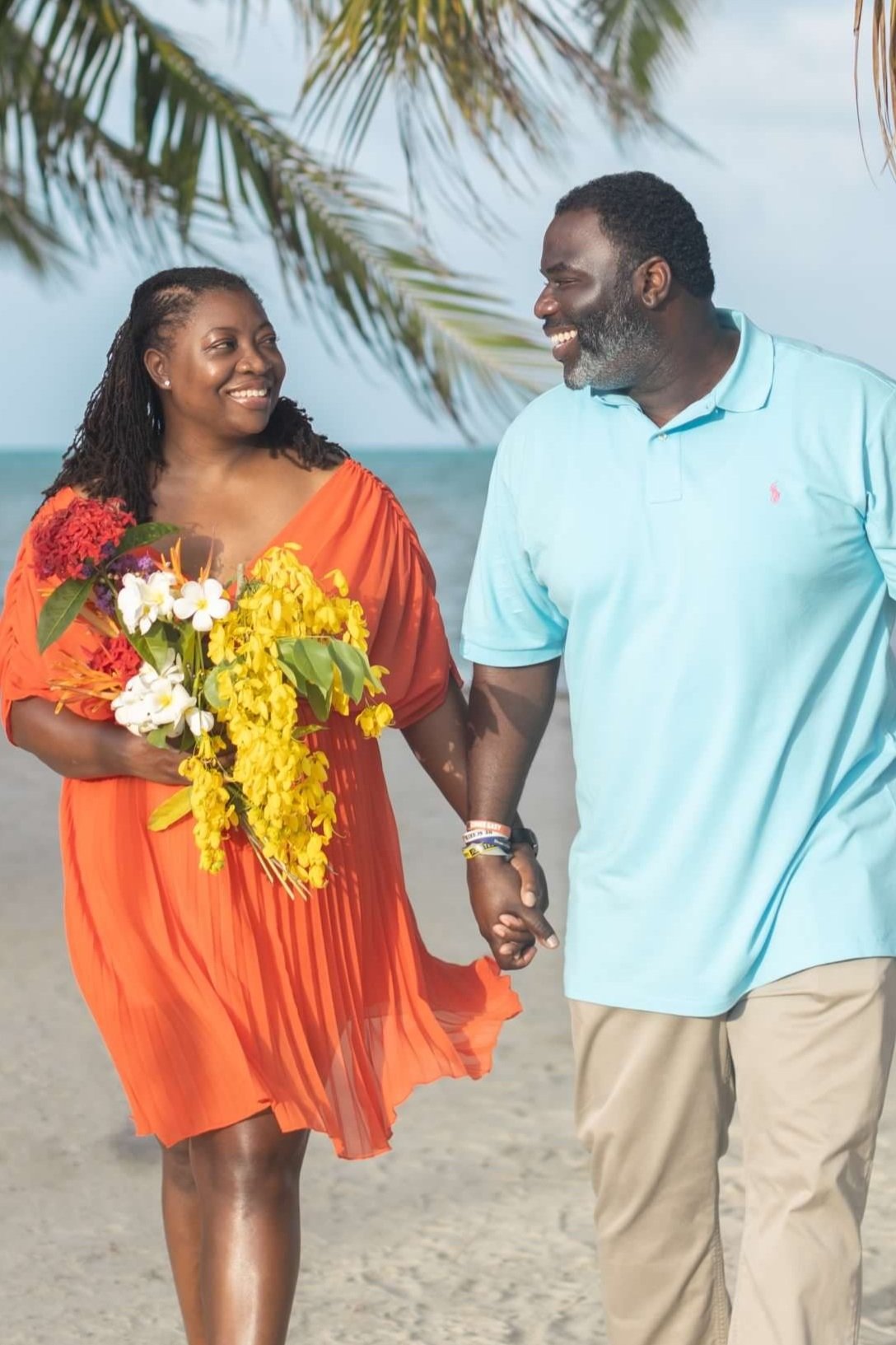 black couple holding hands and lovingly gazing and smiling at each other