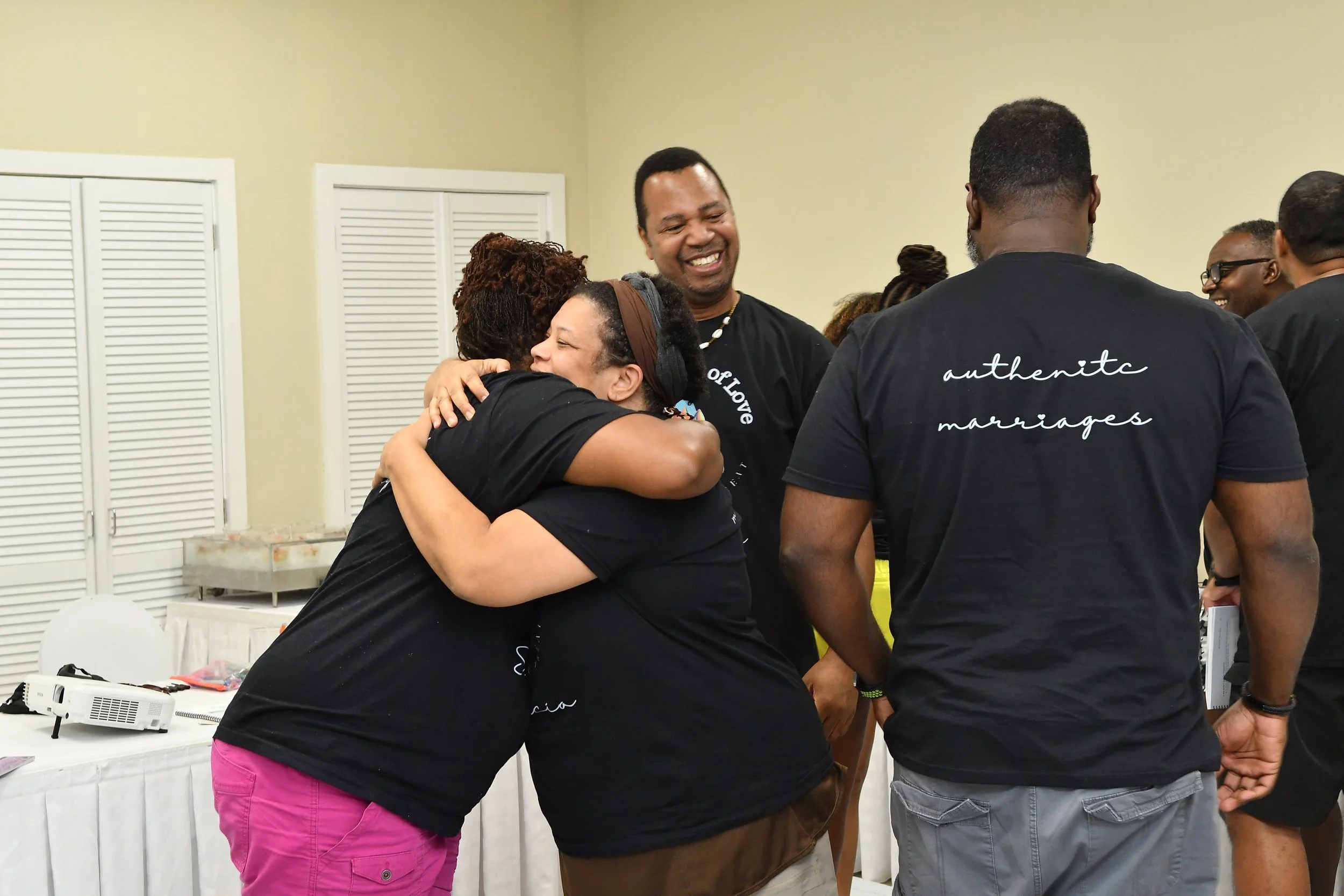wives hugging at couples intensives