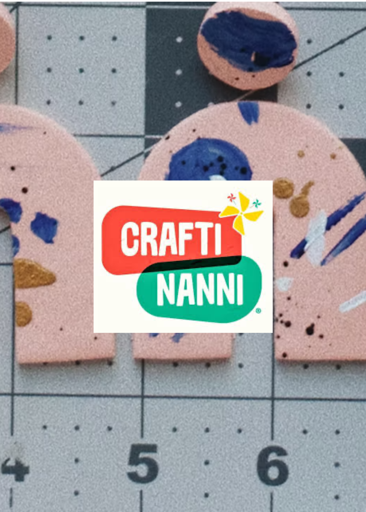 Part of a climbing wall with pink, blue, and brown holds, and a Raindrops logo overlay.