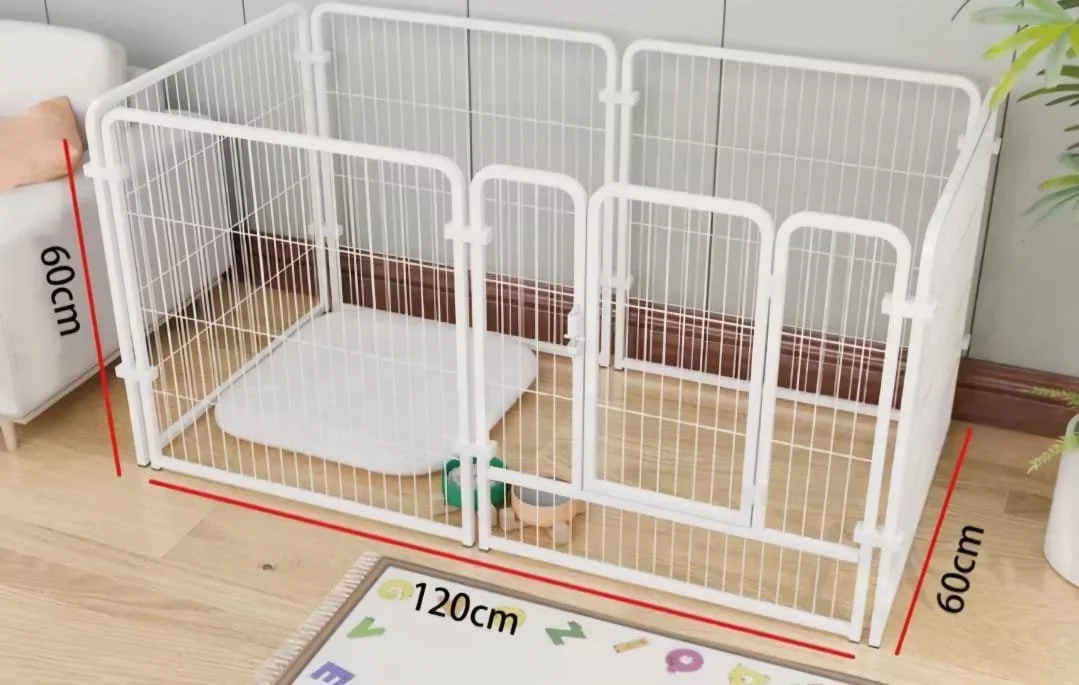 A white pet playpen with two locked gates, measuring 60 cm tall and 120 cm wide, set up on a wooden floor next to a white cabinet with a pillow, and a white mat inside.