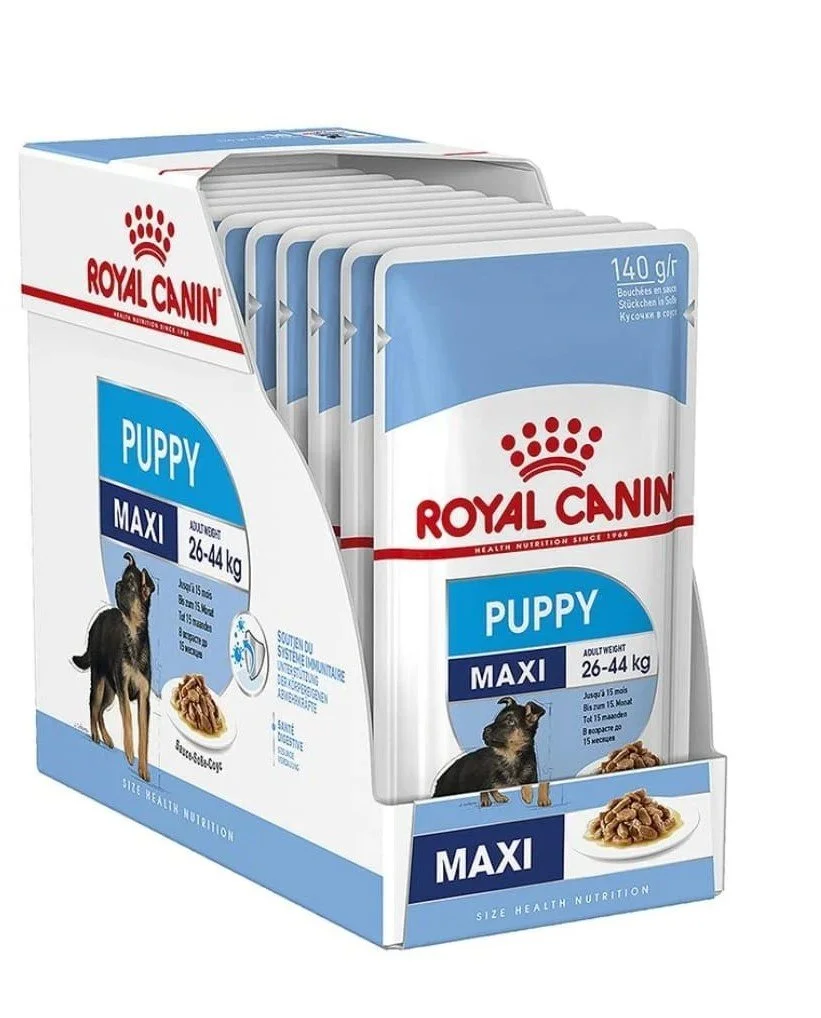 Multiple packets of Royal Canin puppy dry dog food in a display box.