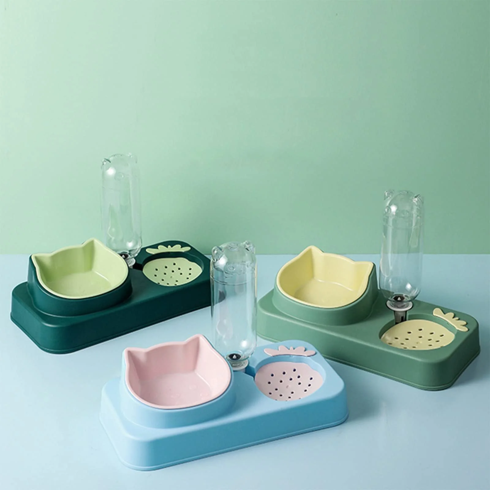 Three colorful baby feeding sets with bowls, bottles, and plate inserts on a pastel-colored background.