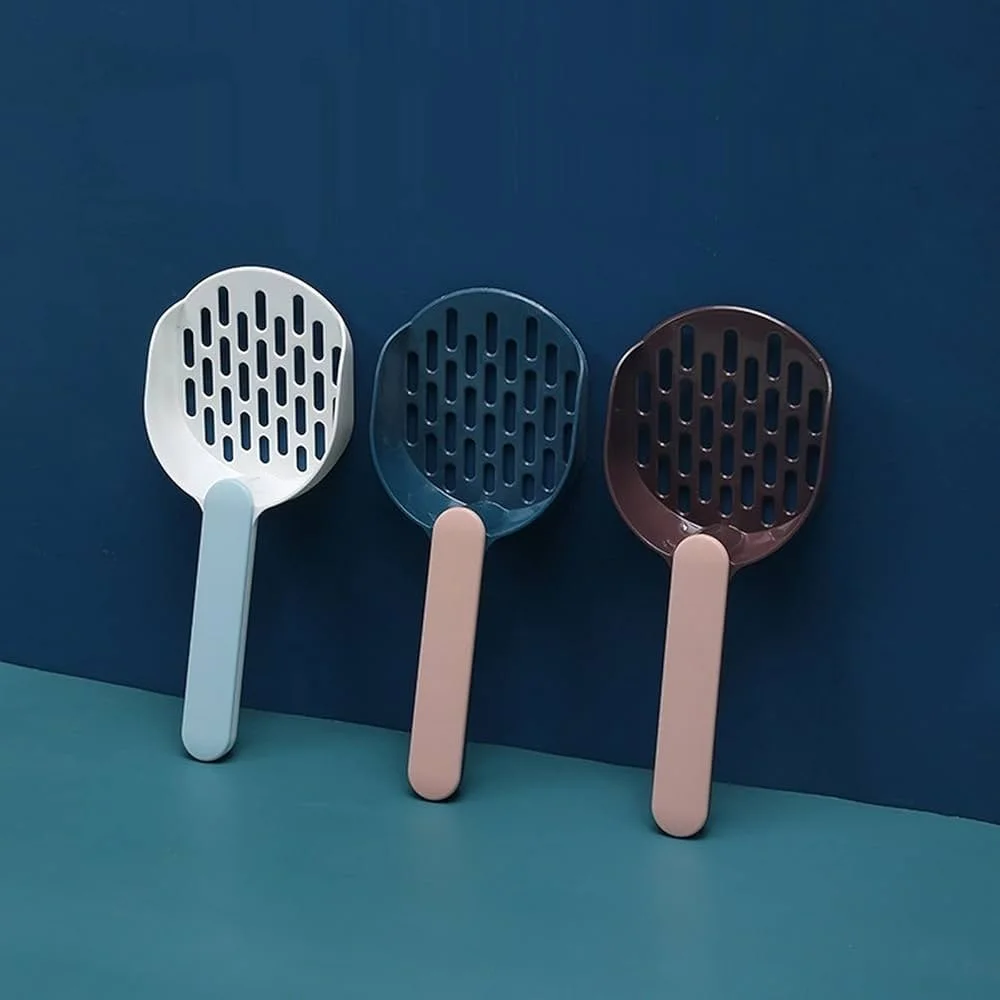 Three colorful plastic scoops with slotted baskets, lined up side by side on a blue surface.