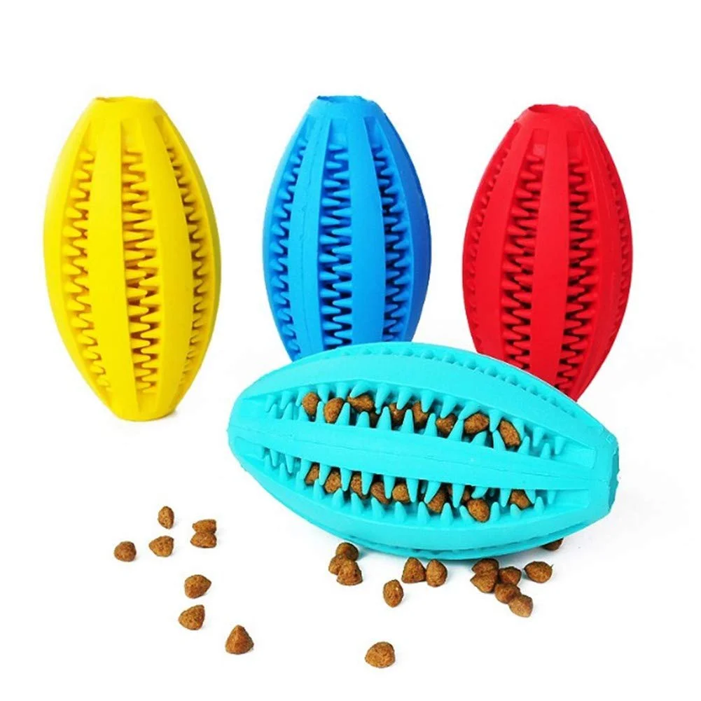 Colorful rubber pet toys shaped like eggs with scattered dry pet food.