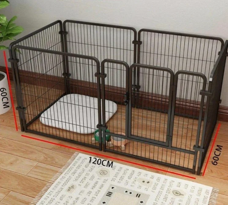 A metal pet playpen with dimensions 120 cm by 60 cm, set on a hardwood floor next to a white wall and a mat with black and white patterns. Inside the playpen are a white cushion and a green bottle.