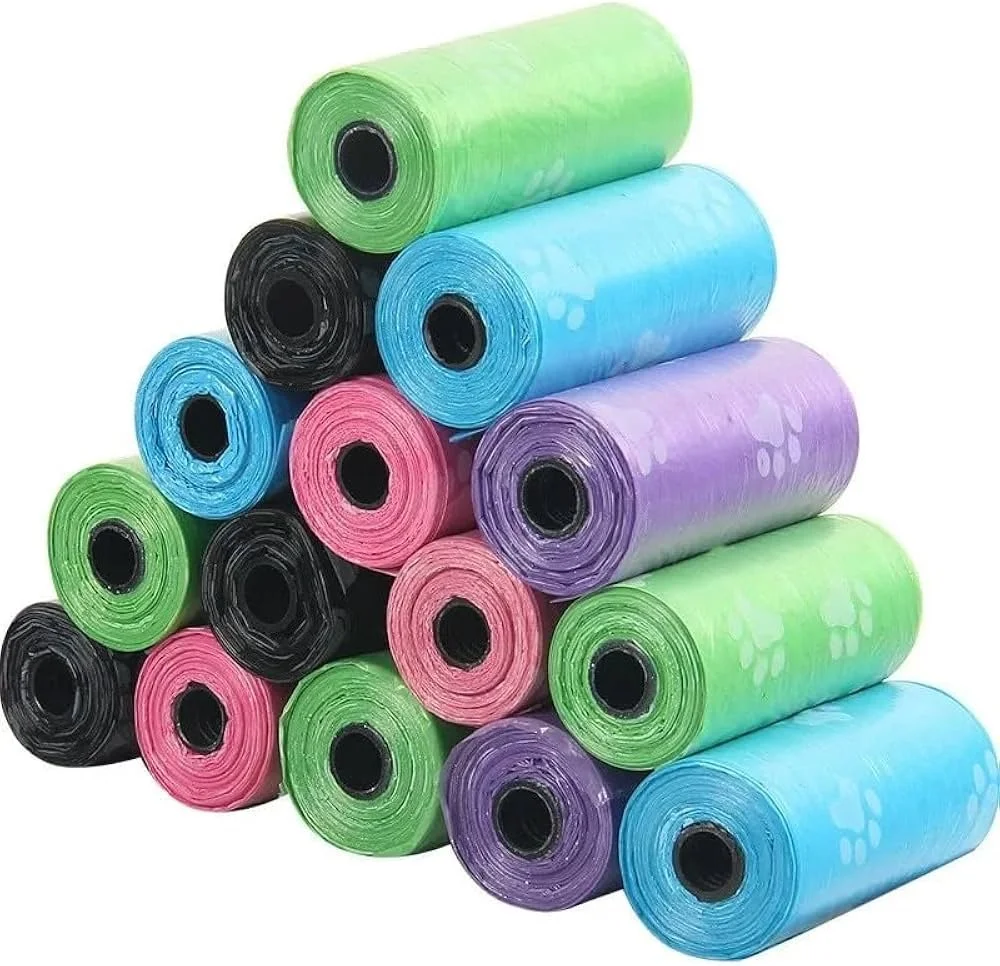 Stacked colorful plastic bags in green, blue, pink, purple, and black with black central holes.