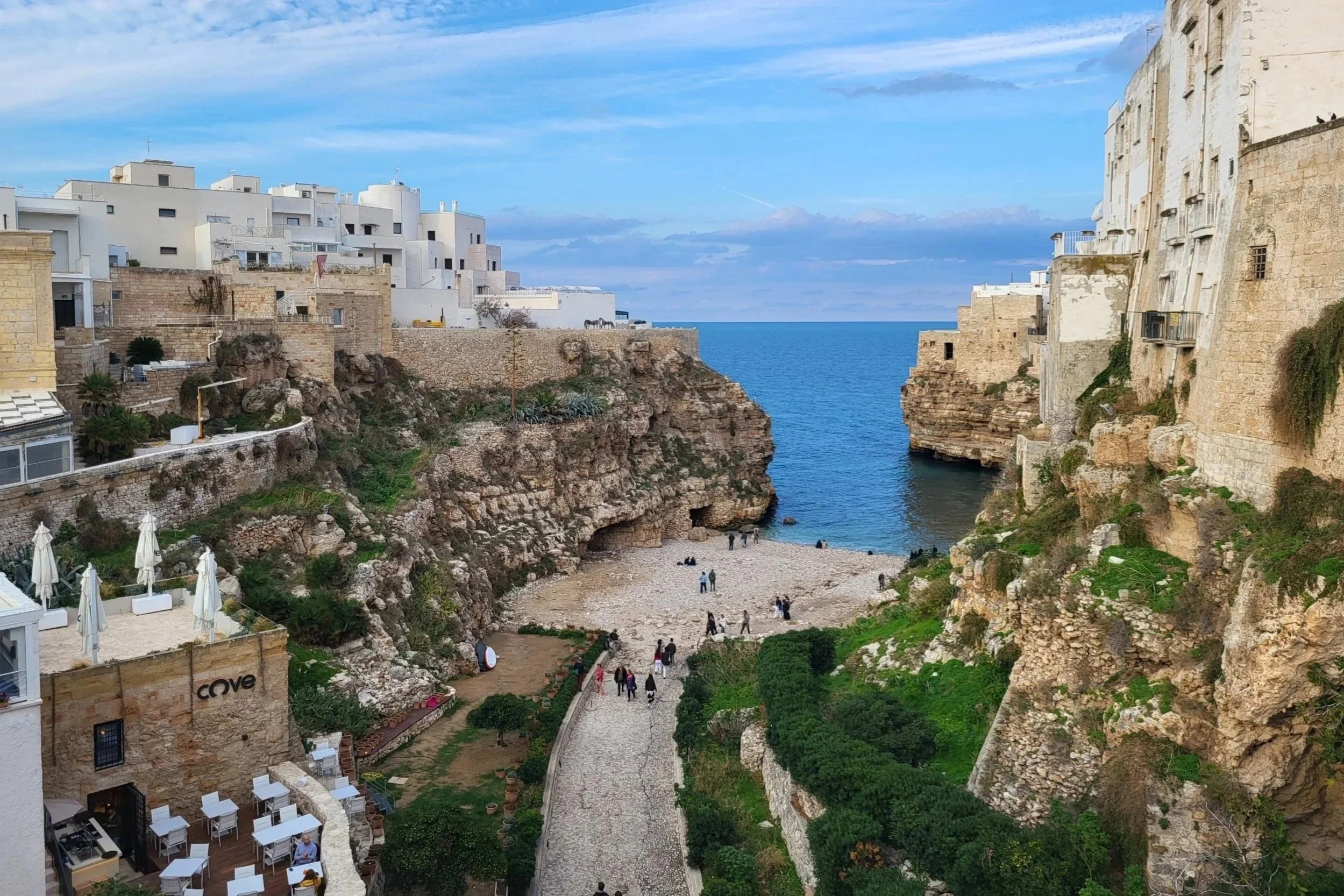 Polignano a Mare beach with cliffs and crystal-clear Adriatic Sea in Puglia.