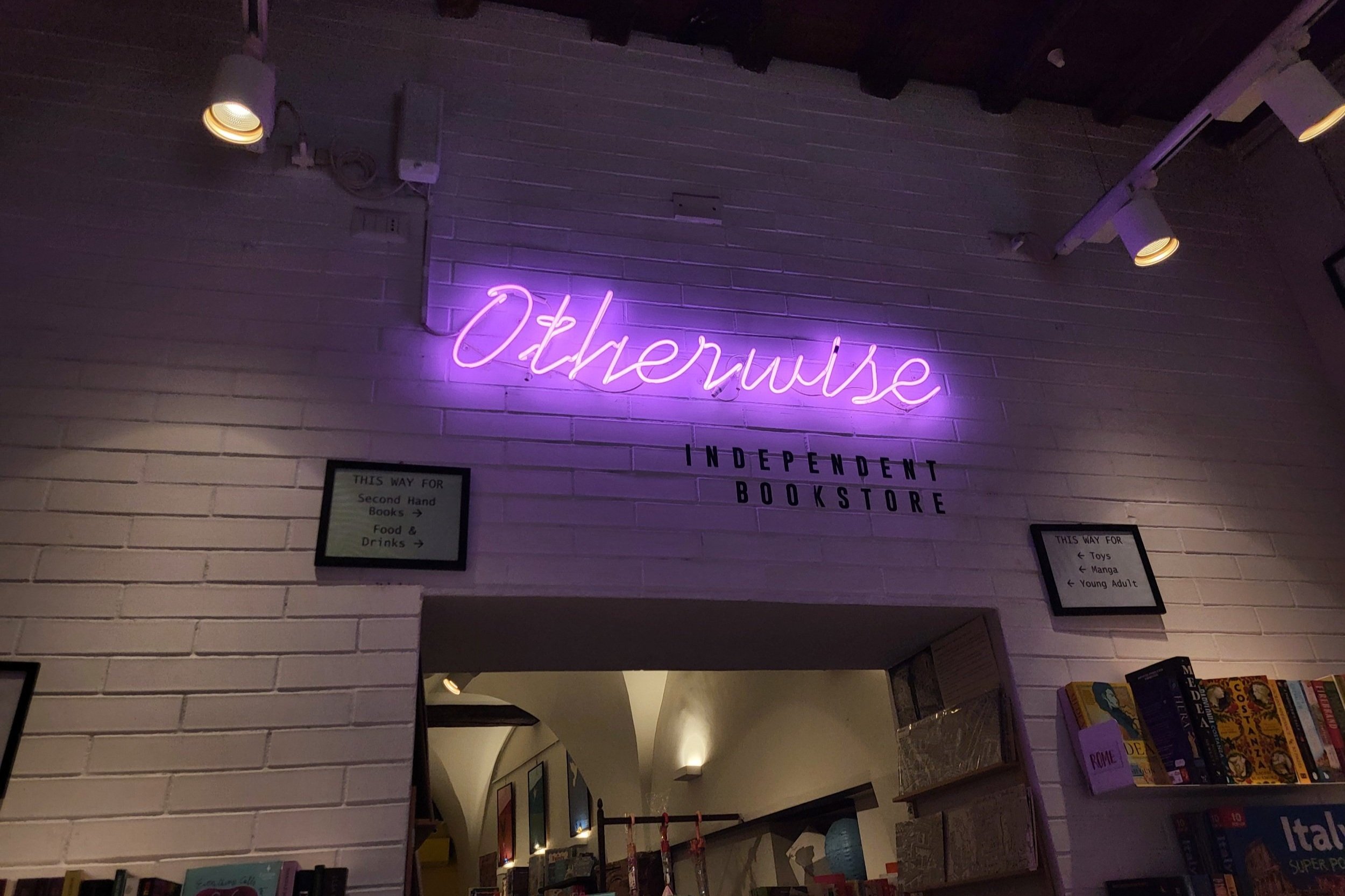 Neon sign that says Otherwise in Otherwise independent bookstore in Rome.