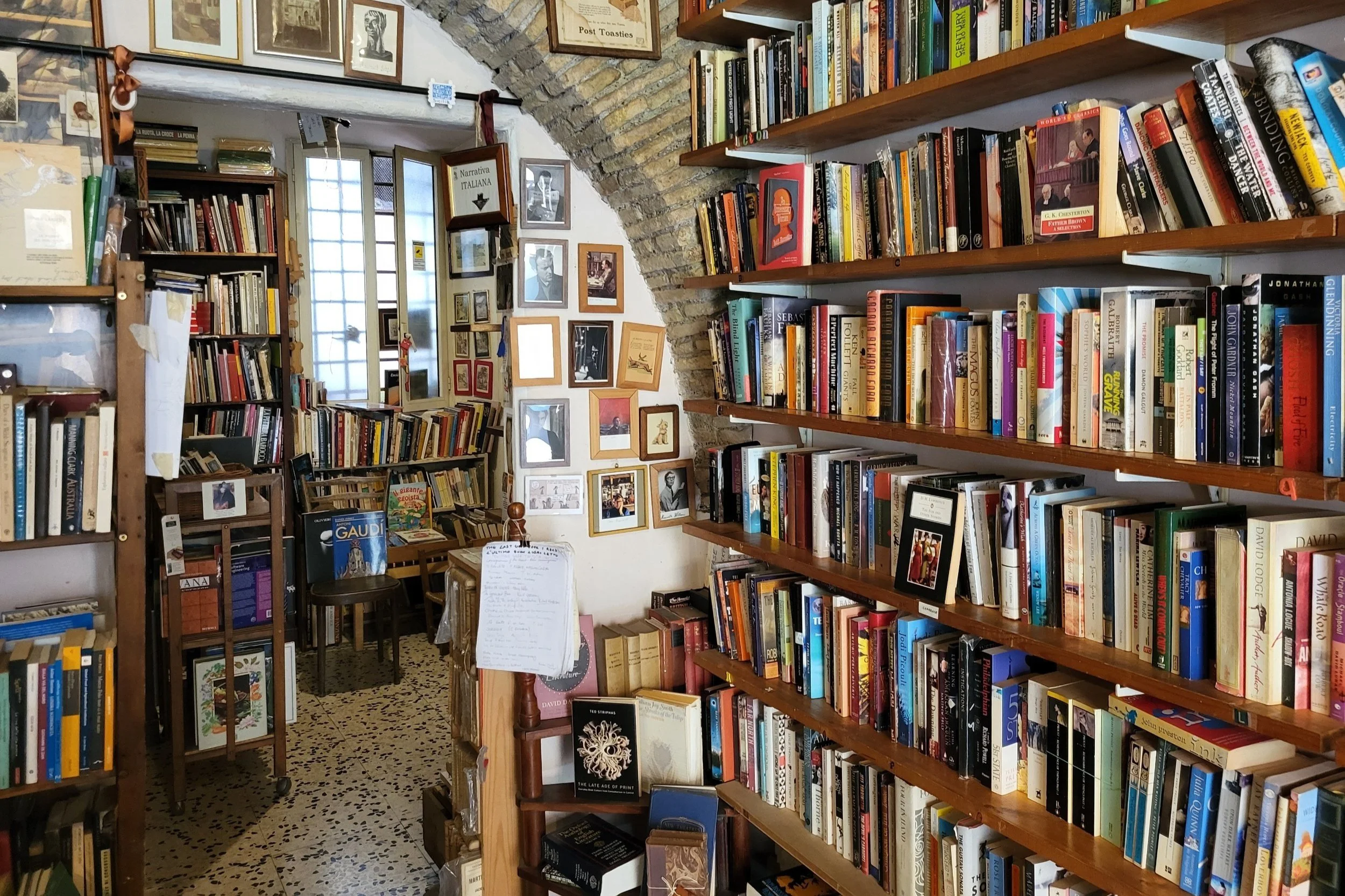 Inside The Open Door Bookshop with shelves of used English and Italian books
