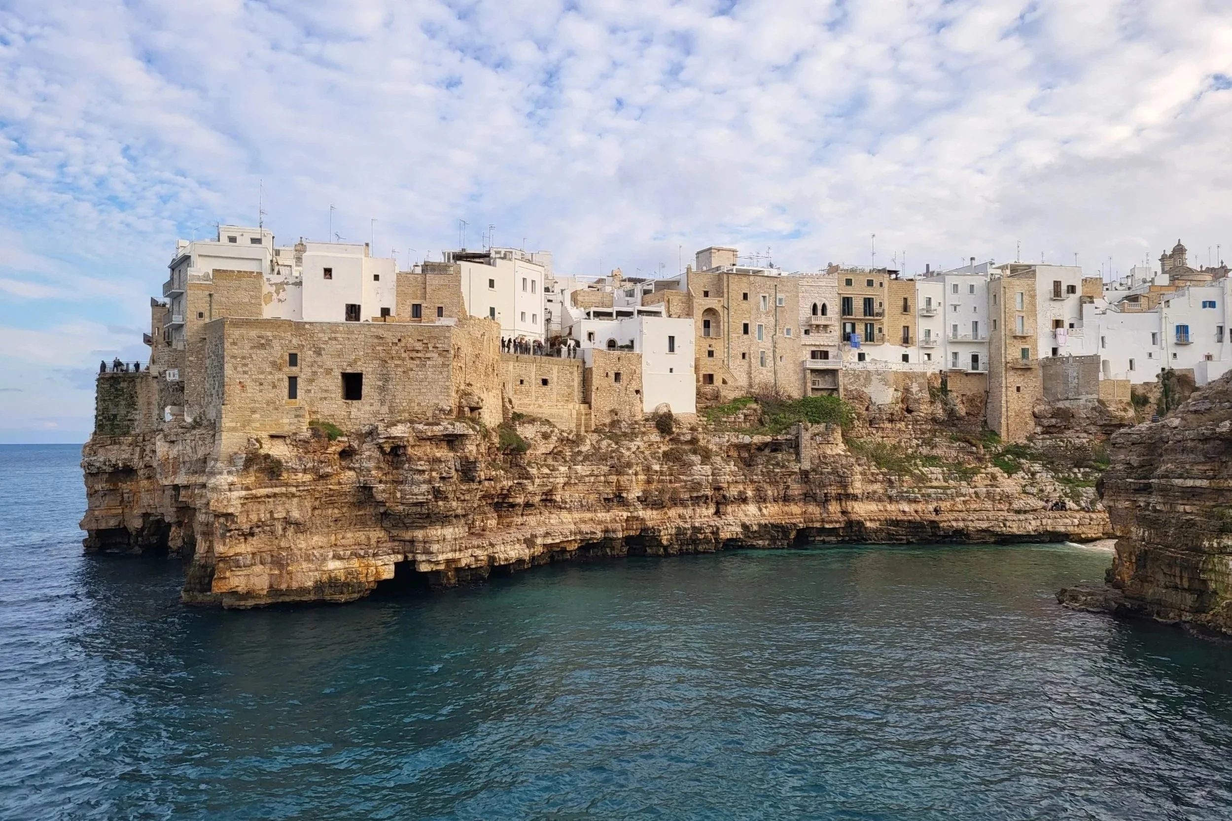 Polignano a Mare beach with cliffs and crystal-clear Adriatic Sea in Puglia.