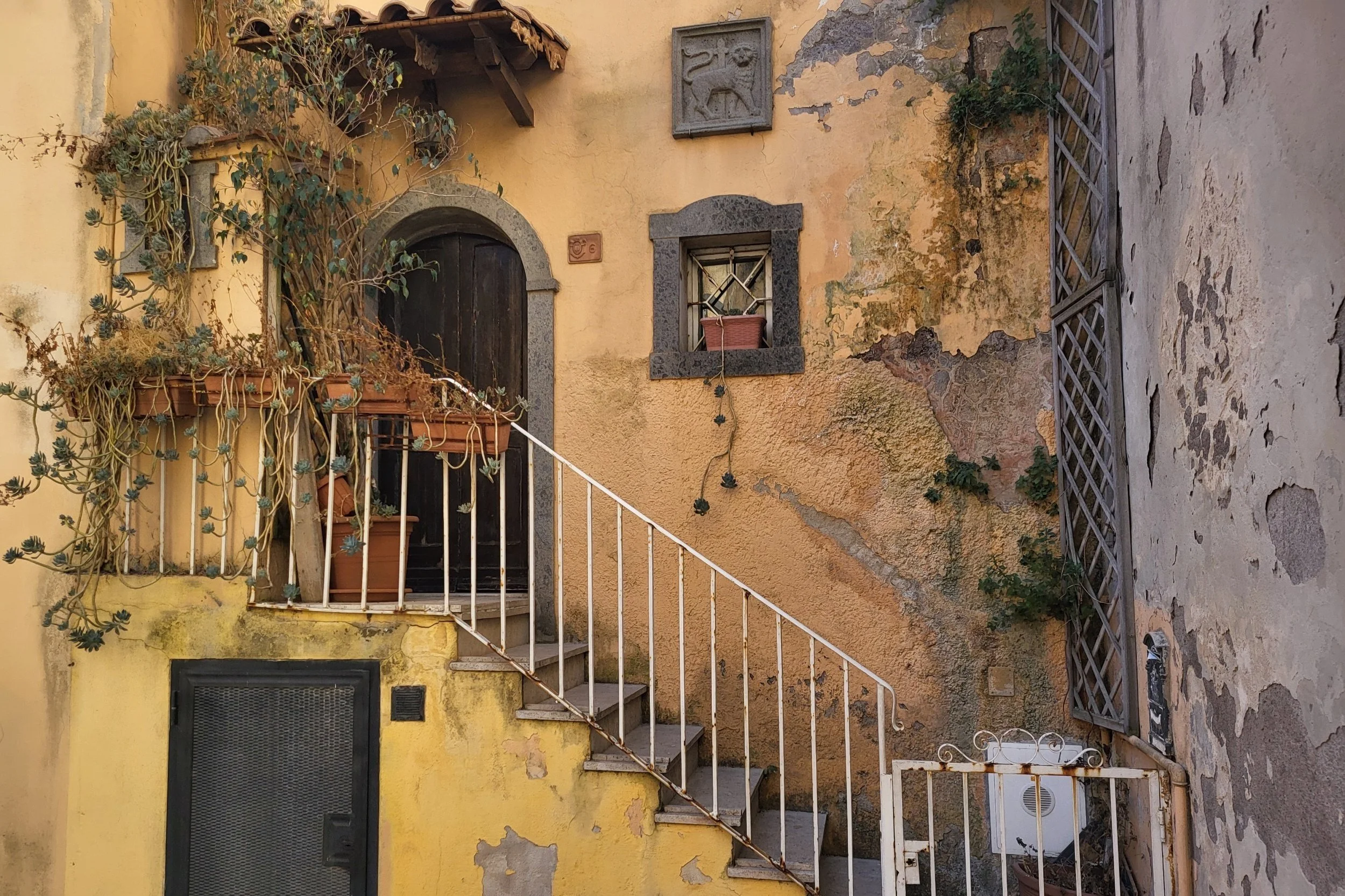 Historic buildings in Nettuno’s old town with arched doorways and rustic charm