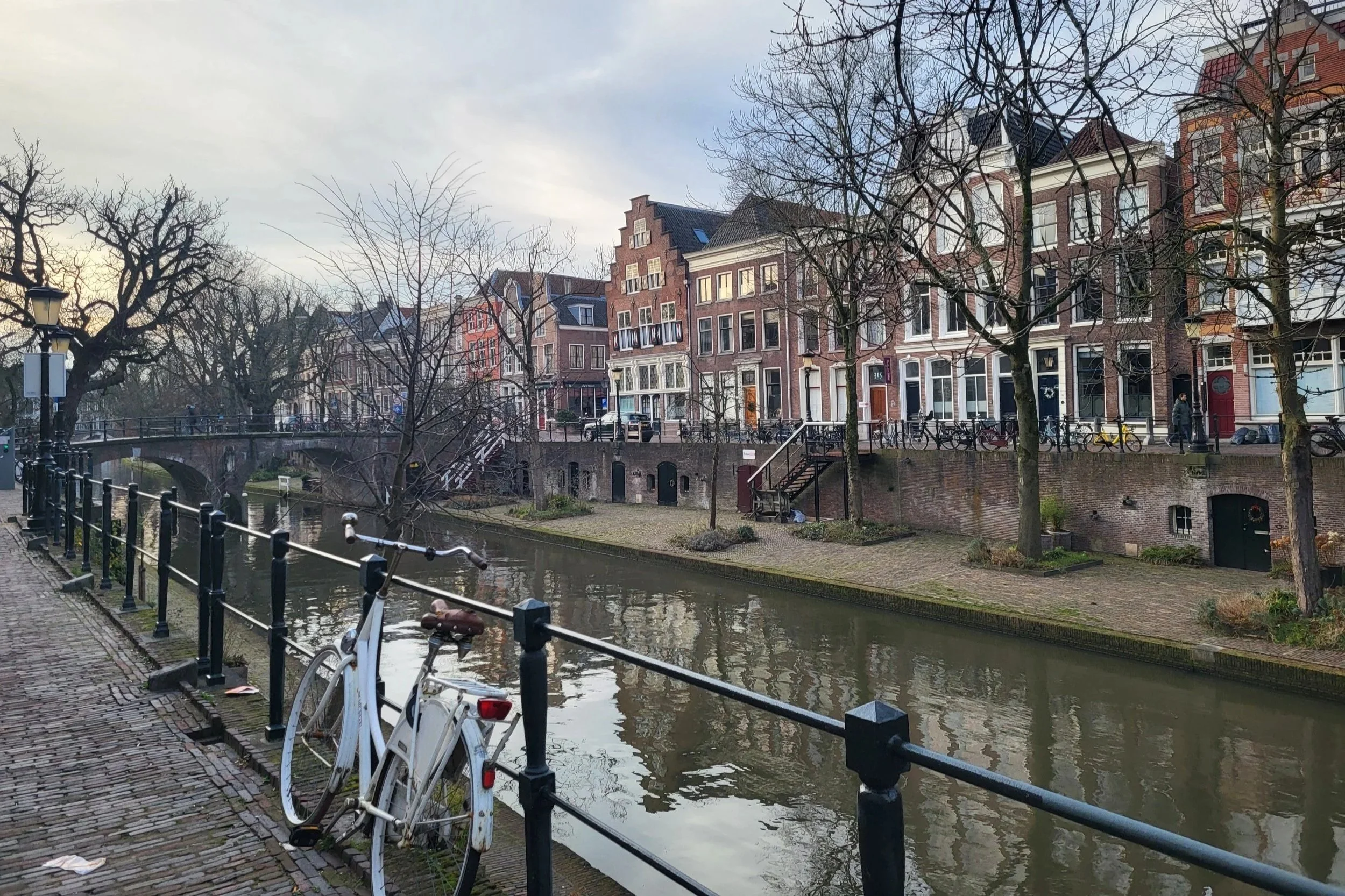 Picturesque Utrecht canal with bicycles, old houses and calm water atmosphere