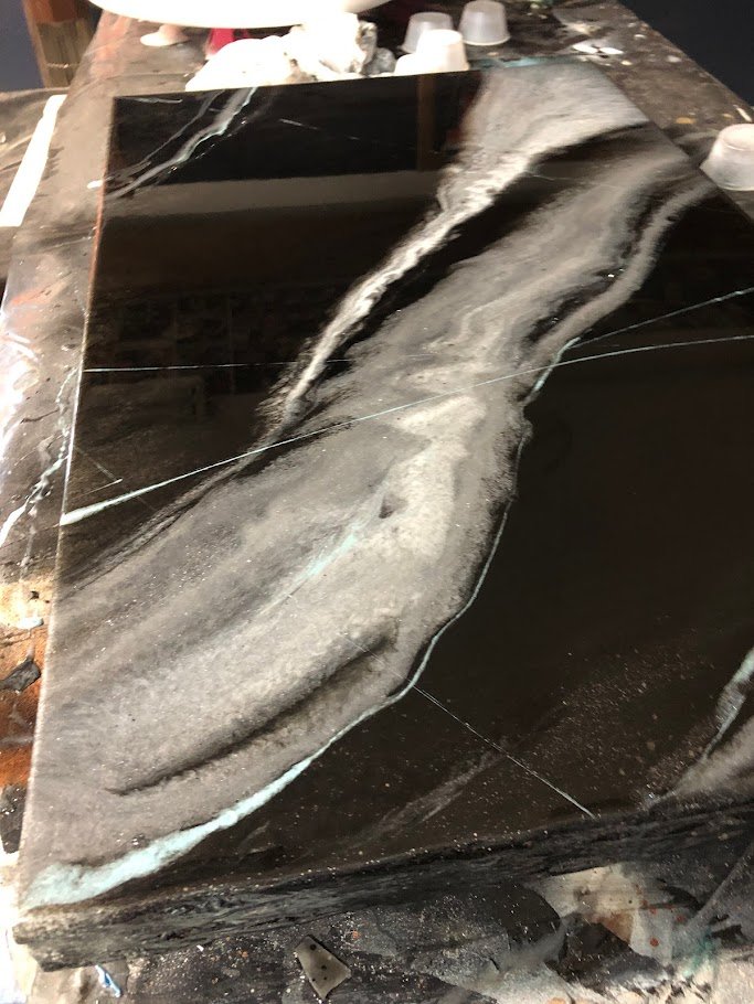 Witness the intricate beauty of our custom epoxy countertop, showcasing exquisite veins created with white and teal highlights. The delicate veining adds a touch of elegance and sophistication, perfectly complementing the smooth, glossy finish of the