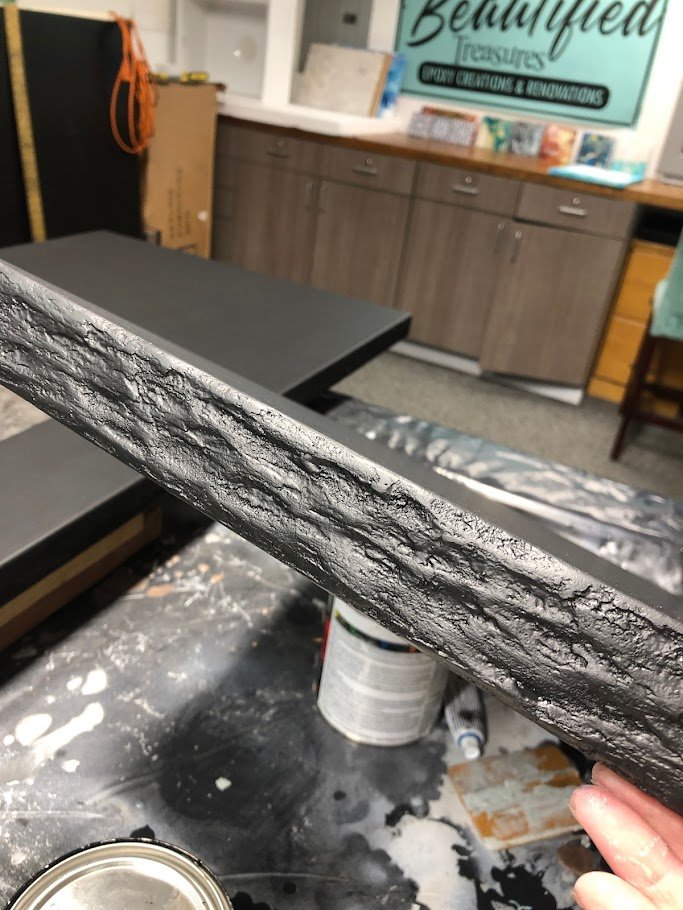 Immerse yourself in the stunning craftsmanship of our custom epoxy countertops, now enhanced with a unique rock edge effect. The edges of this countertop mimic the natural texture and appearance of stone, adding a rustic and organic feel to the sleek