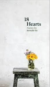 A book cover titled '18 Hearts' by Renato Sa with a glass jar of yellow flowers on a gray wooden table against a plain white wall.