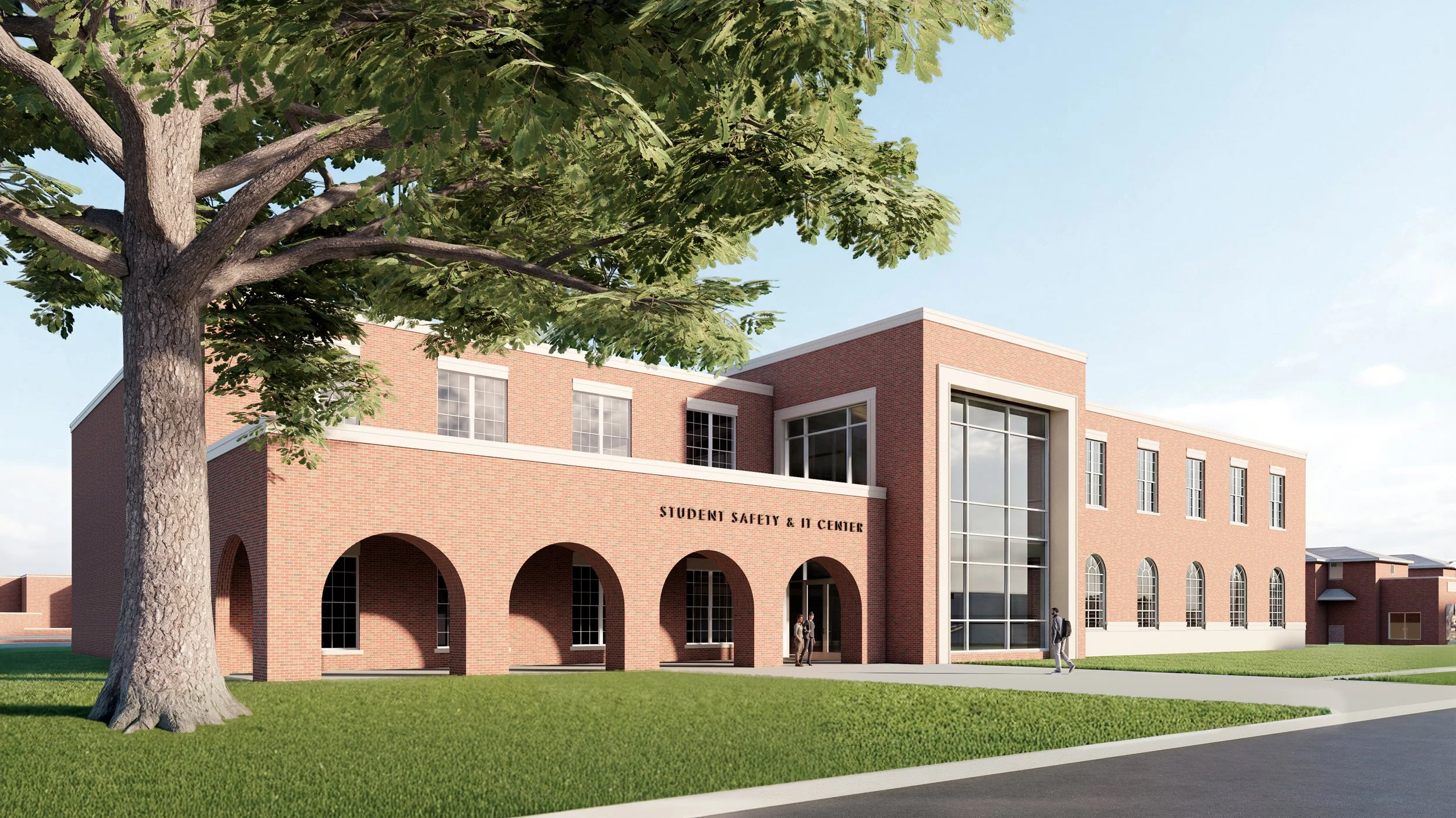 Rendering of the proposed Student Safety and IT Center at Tyler Junior College. The image shows a two-story brick building with large windows, arched entryways, landscaped lawn, and a sidewalk in front.