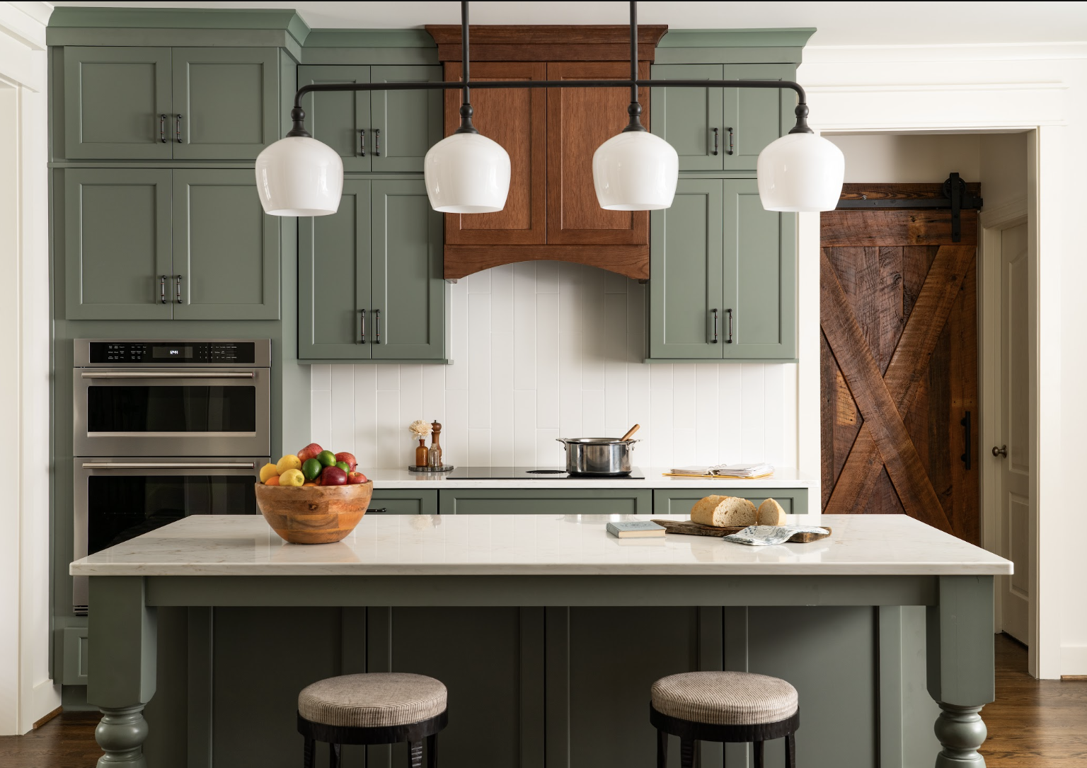 Green kitchen with wood hood