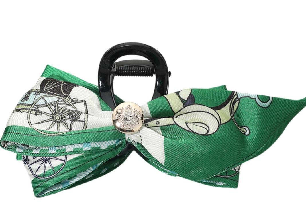 Green horse print bow hair claw clip with equestrian carriage design