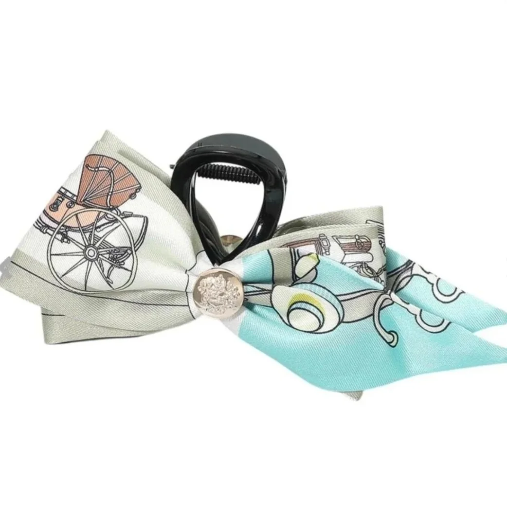 Aqua horse print bow hair claw clip with equestrian carriage design