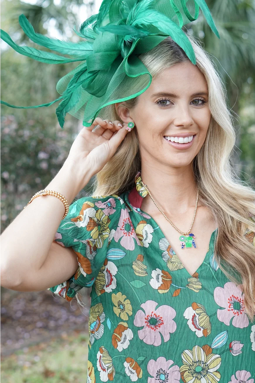 Woman wearing green and pink prize winning ribbon enamel stud earrings