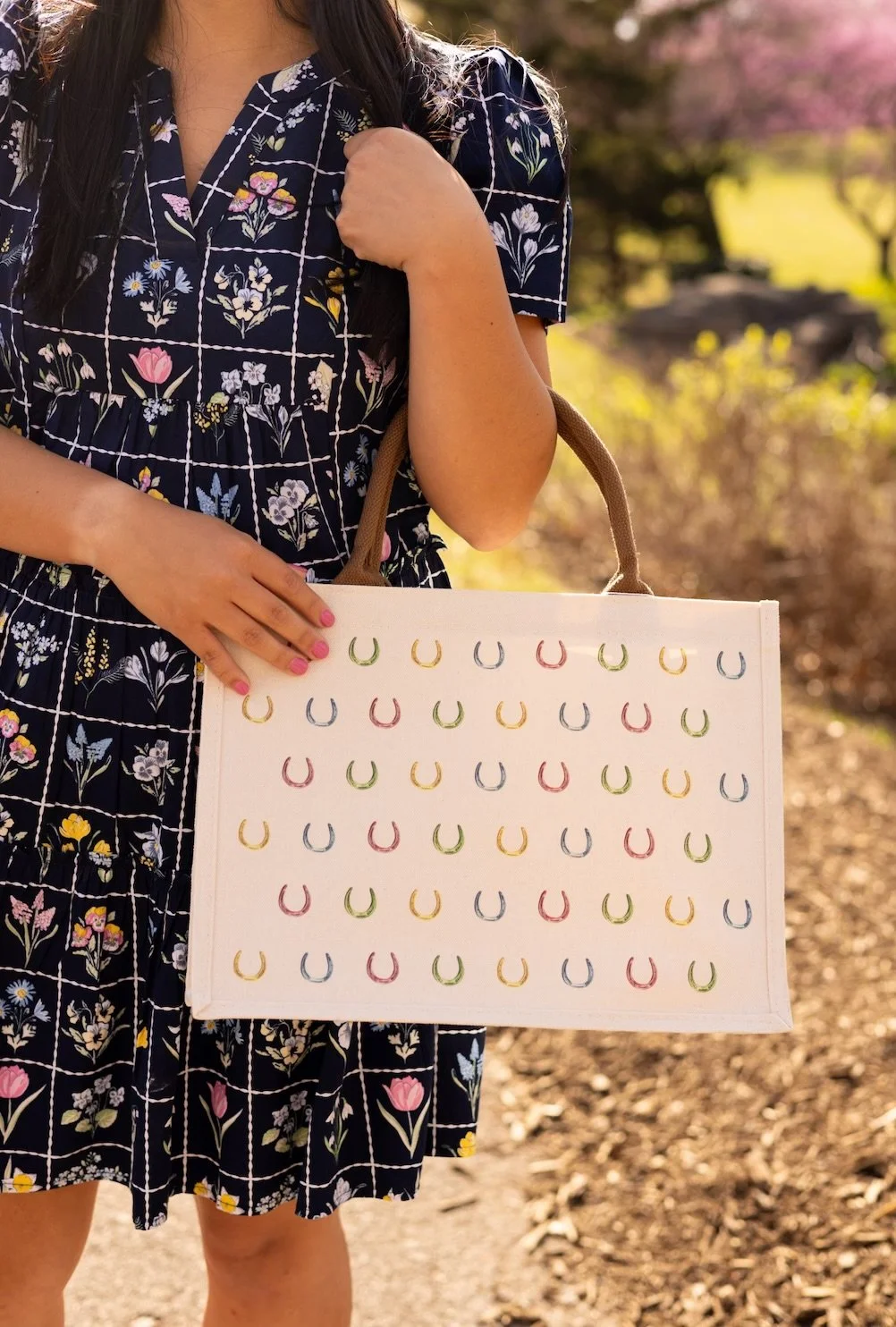 Multi Color Horseshoe Tote Bag with colorful horseshoe pattern shown outdoors
