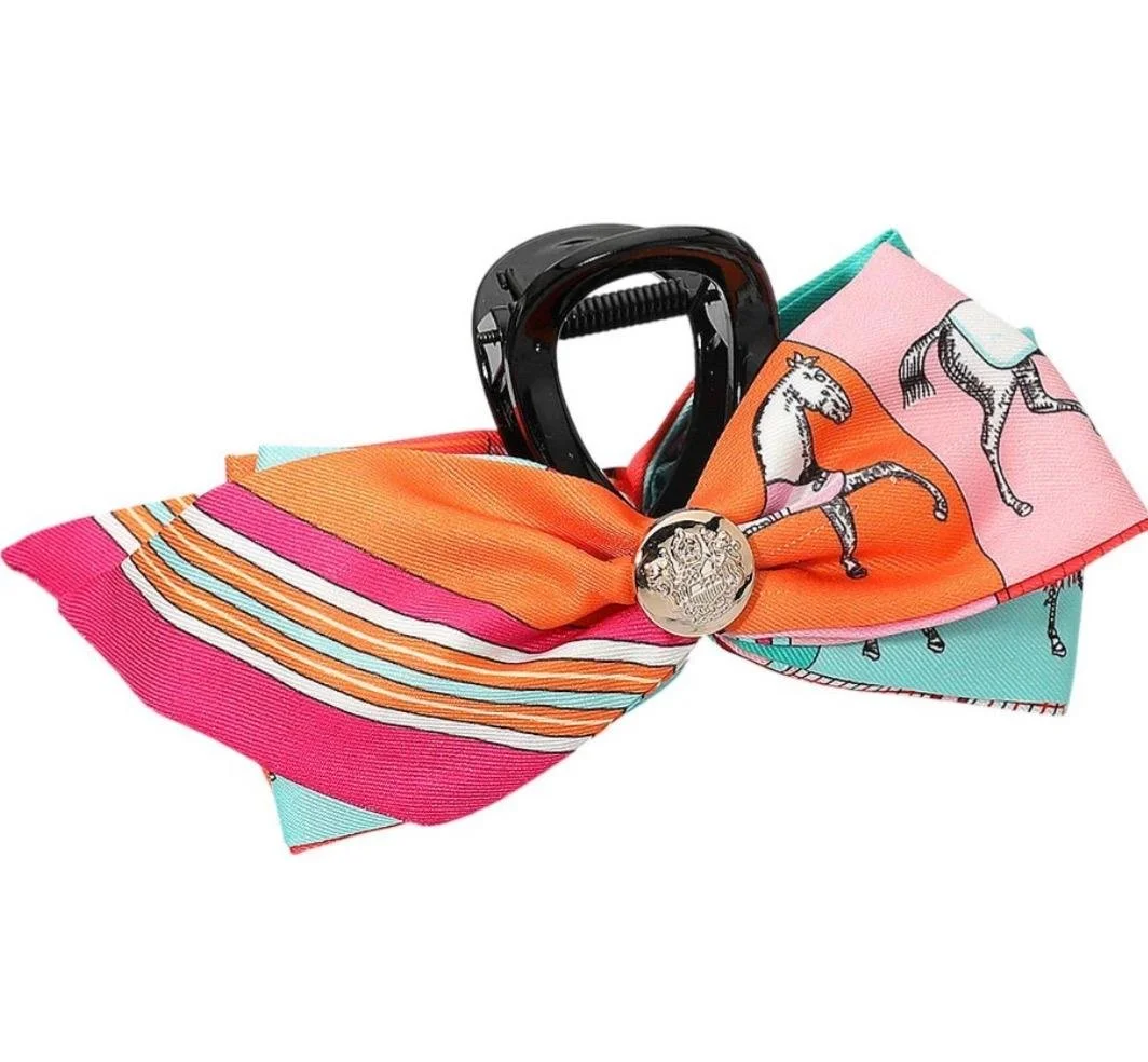 Pink and orange horse print bow hair claw clip with horse silhouette design