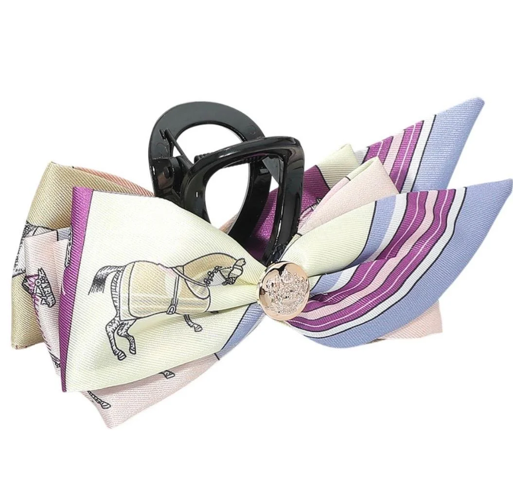 Purple horse print bow hair claw clip with oversized ribbon design