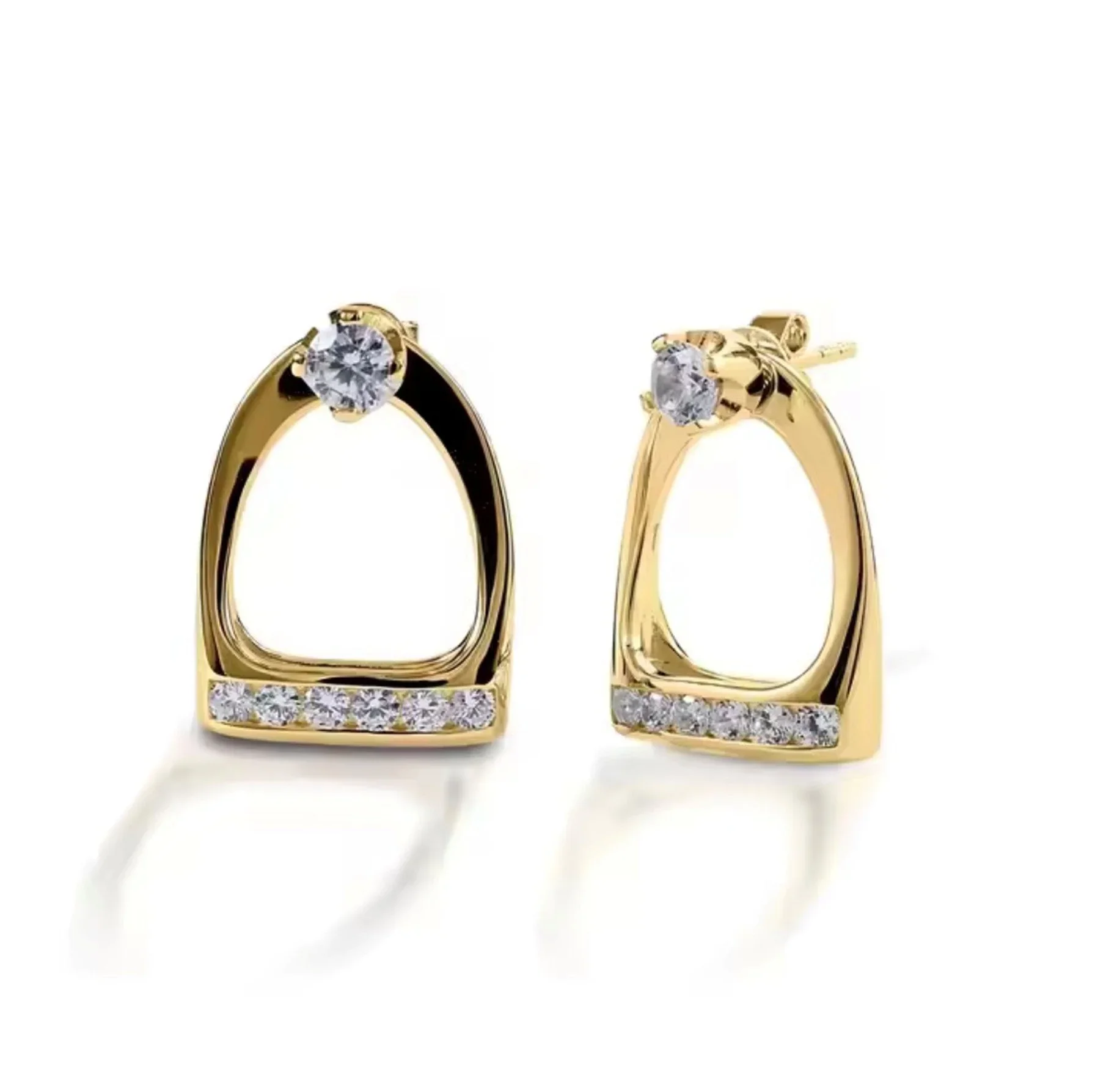 Pair of gold earrings with clear gemstones, open teardrop design, and a row of small stones at the base.