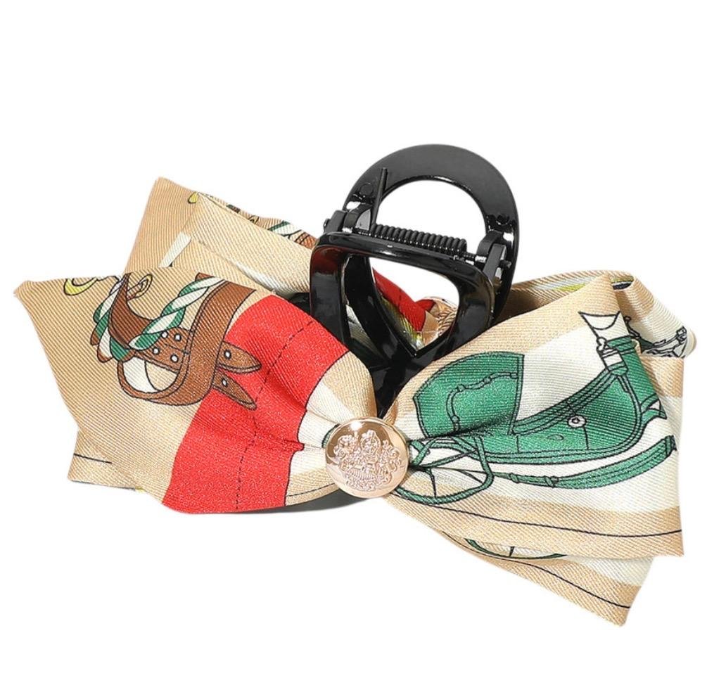 Orange and green horse print bow hair claw clip with equestrian saddle and horse design