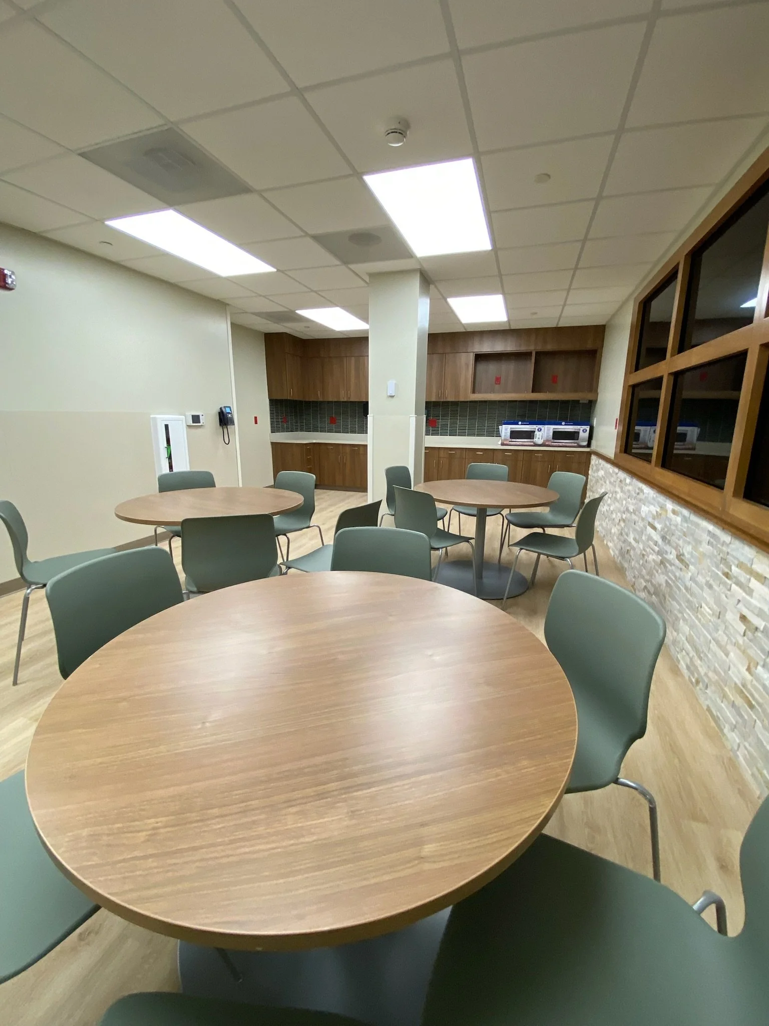 Glens Falls Hospital staff lounge with chairs, tables and a kitchenette