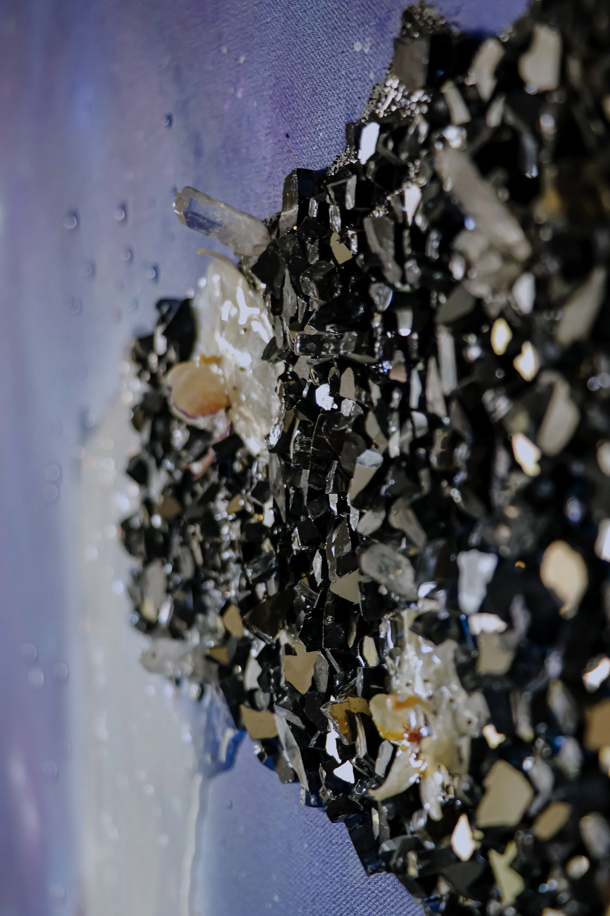 close up detail photo of textured glass, resin and orchid botanical
