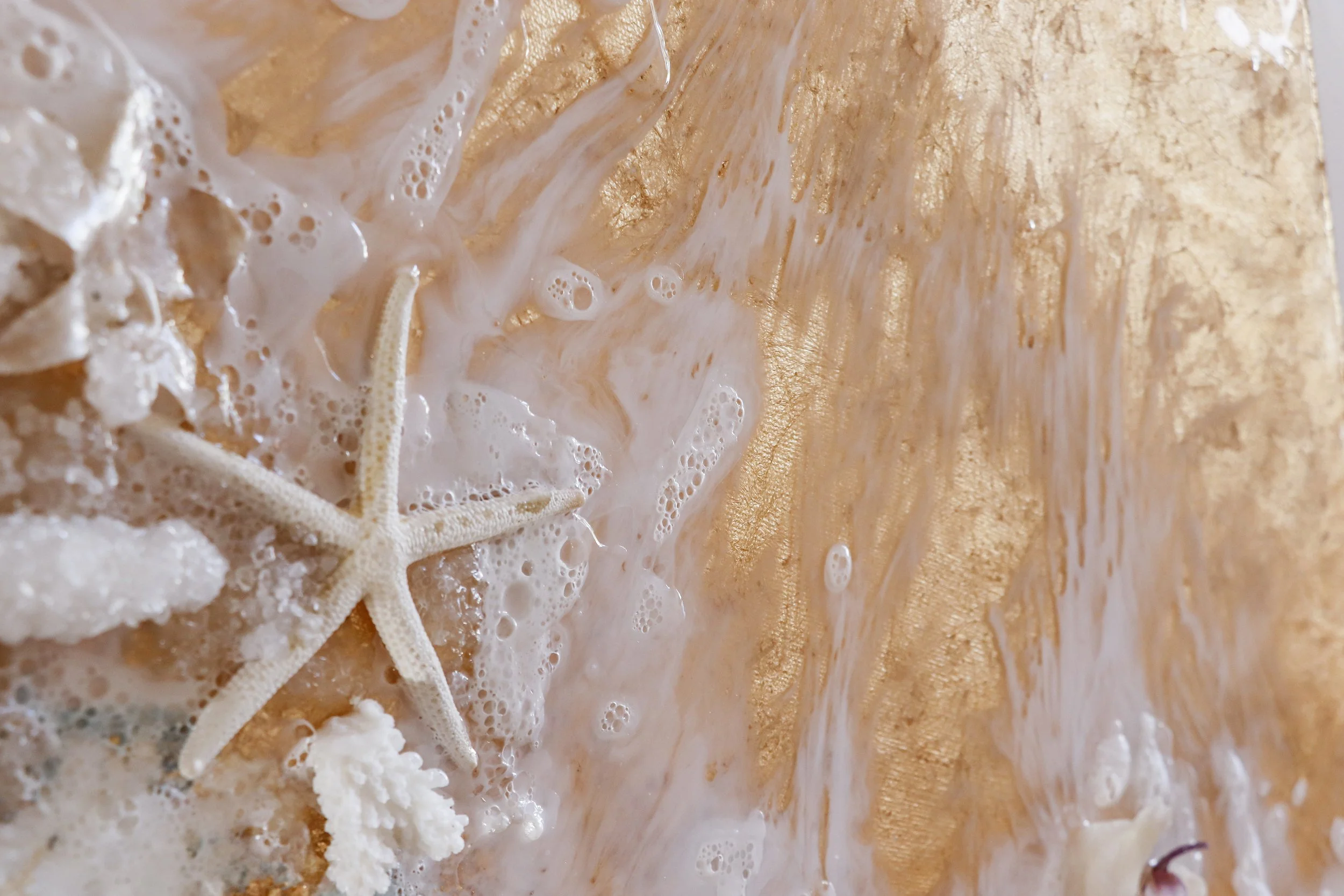 close up detail photo of resin art waves with starfish