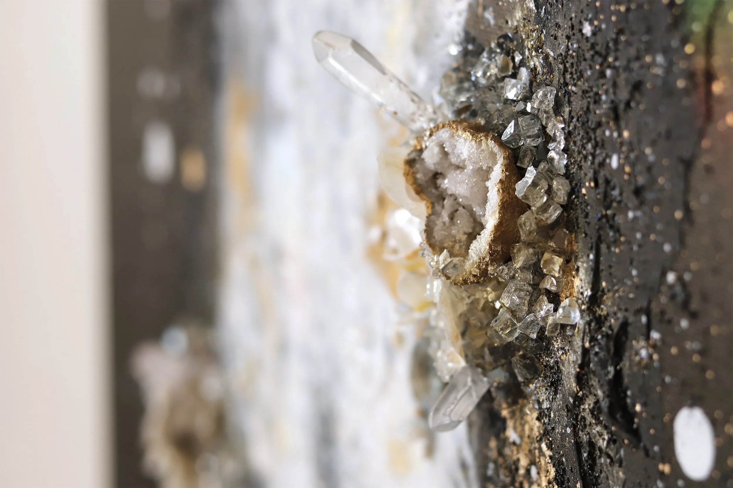 Detail photo of black and white abstract painting with orchid and quartz points
