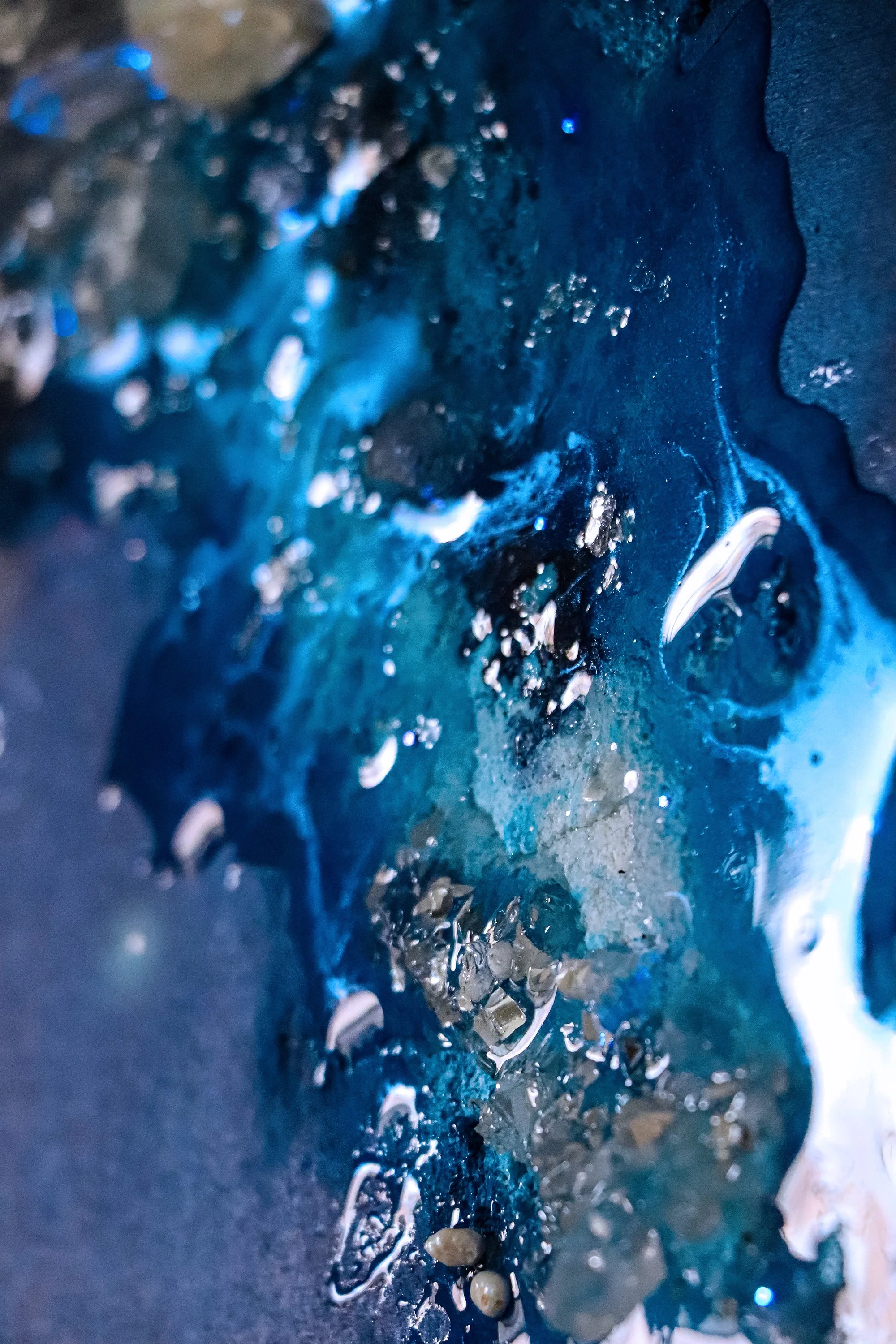 close up detail photo of blue textured wall art with resin