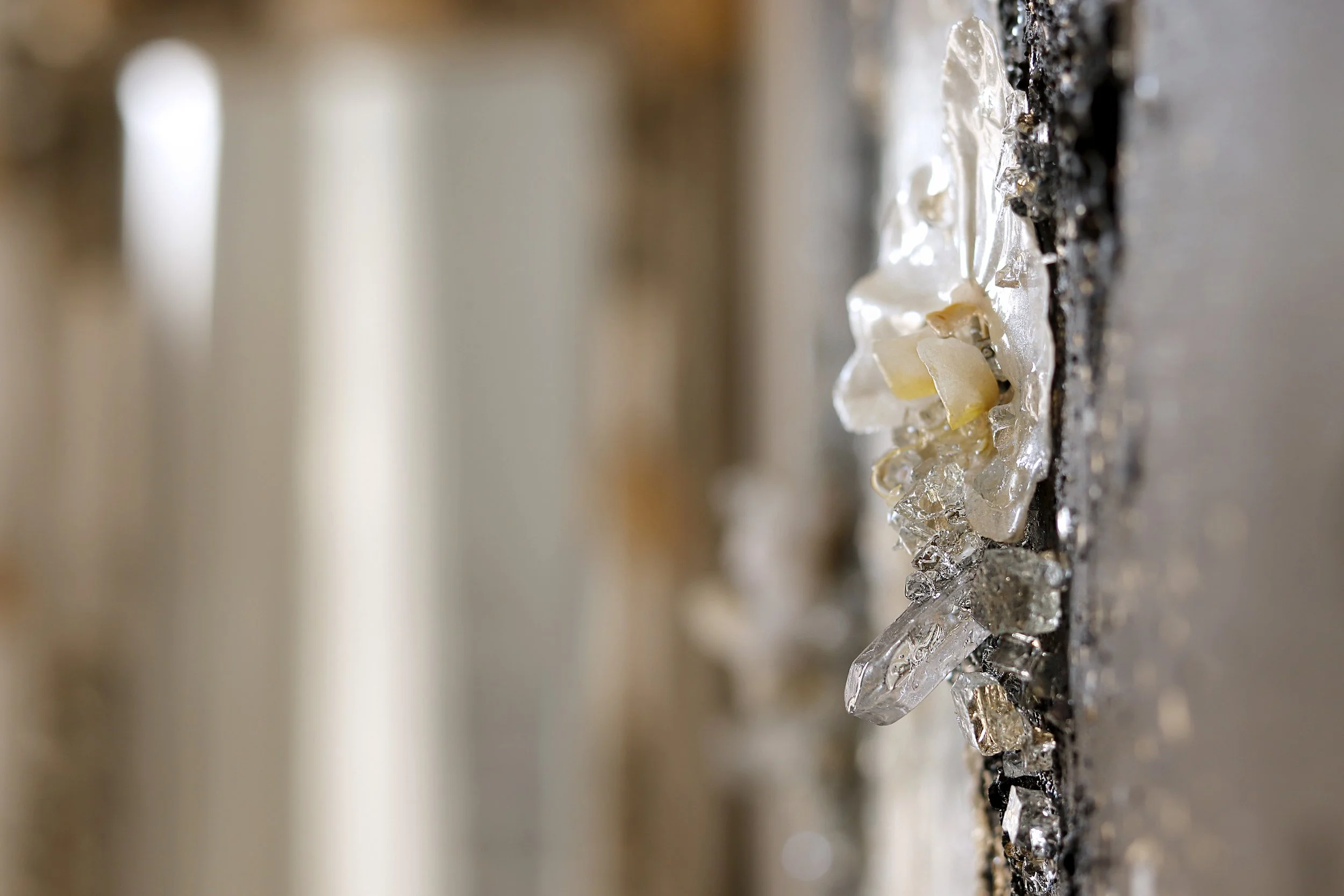 Detail photo of black and white abstract painting with orchid and quartz points