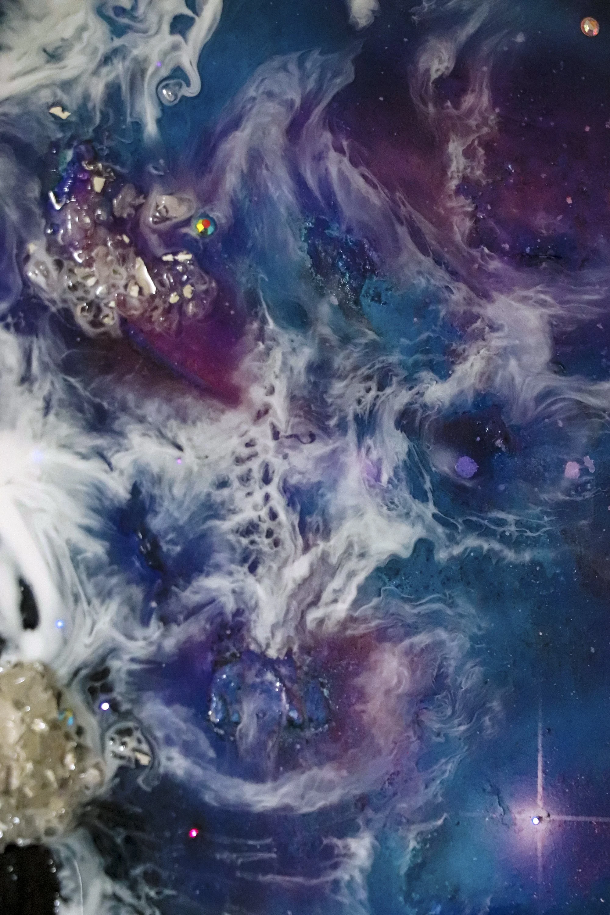 close up detail photo, blue and purple galaxy painting with resin ocean waves over top