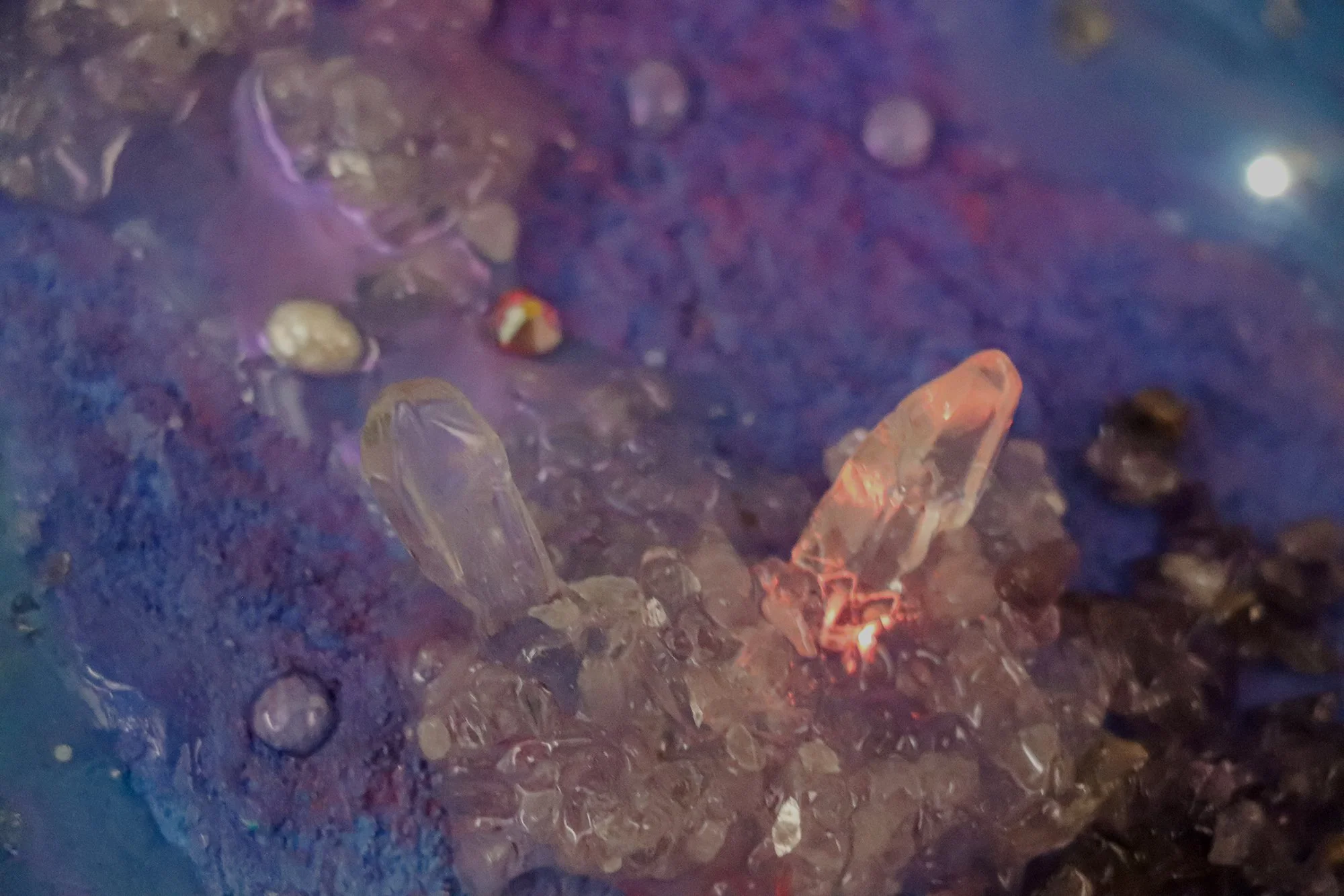 detail close up photo of glowing quartz crystal point on painting