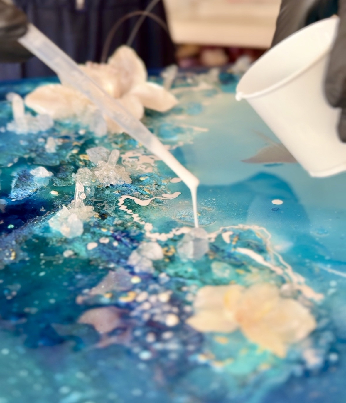 vlose up detail of resin art pour in progress