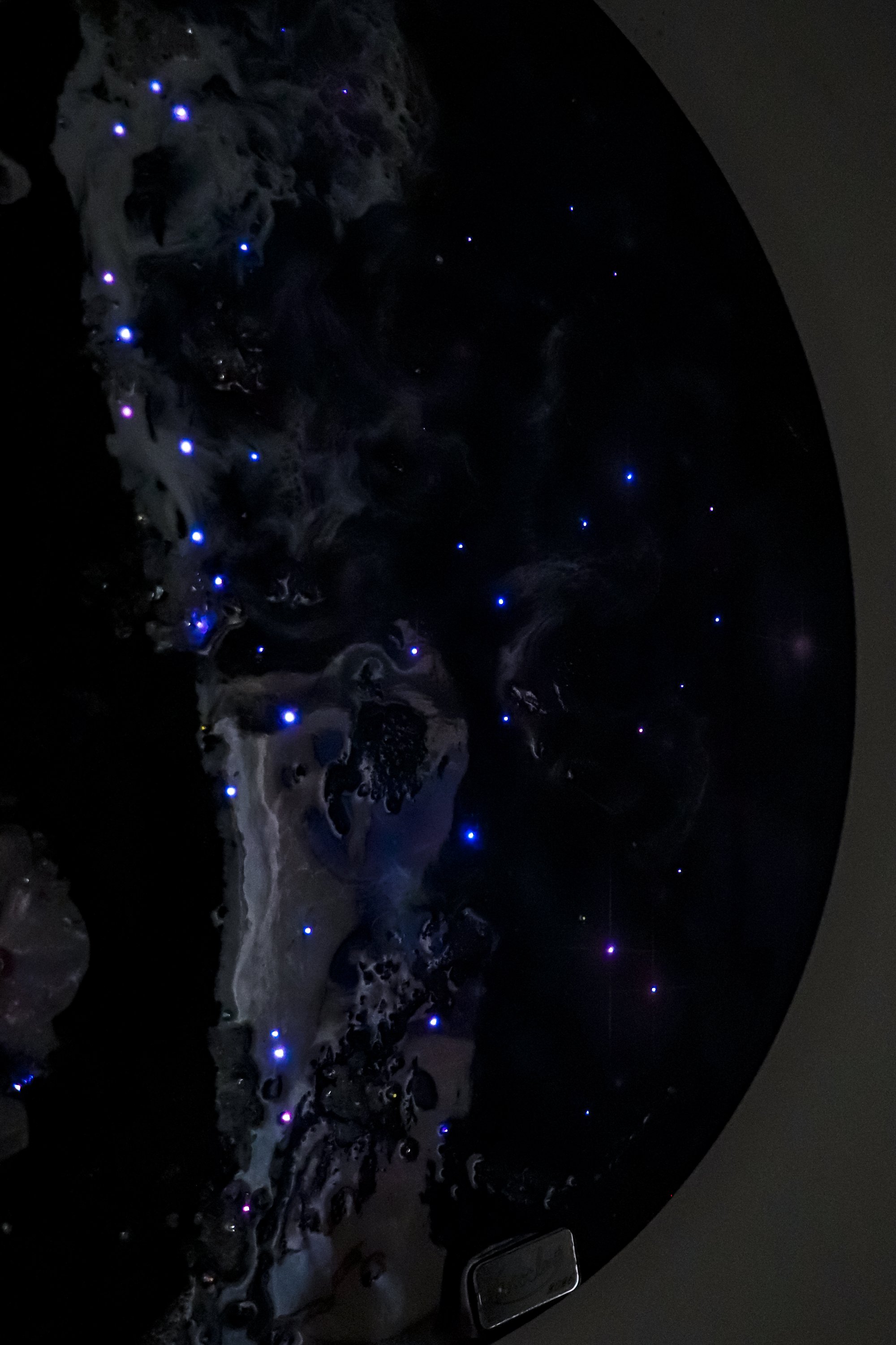 close up detail photo of glowing fiber optic lights with resin wave texture