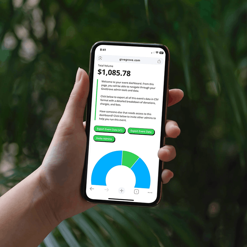 Person holding a smartphone displaying a dashboard with a total volume of $1,085.78, green buttons labeled Export Event Data and Invite Admins, and a blue and green pie chart.