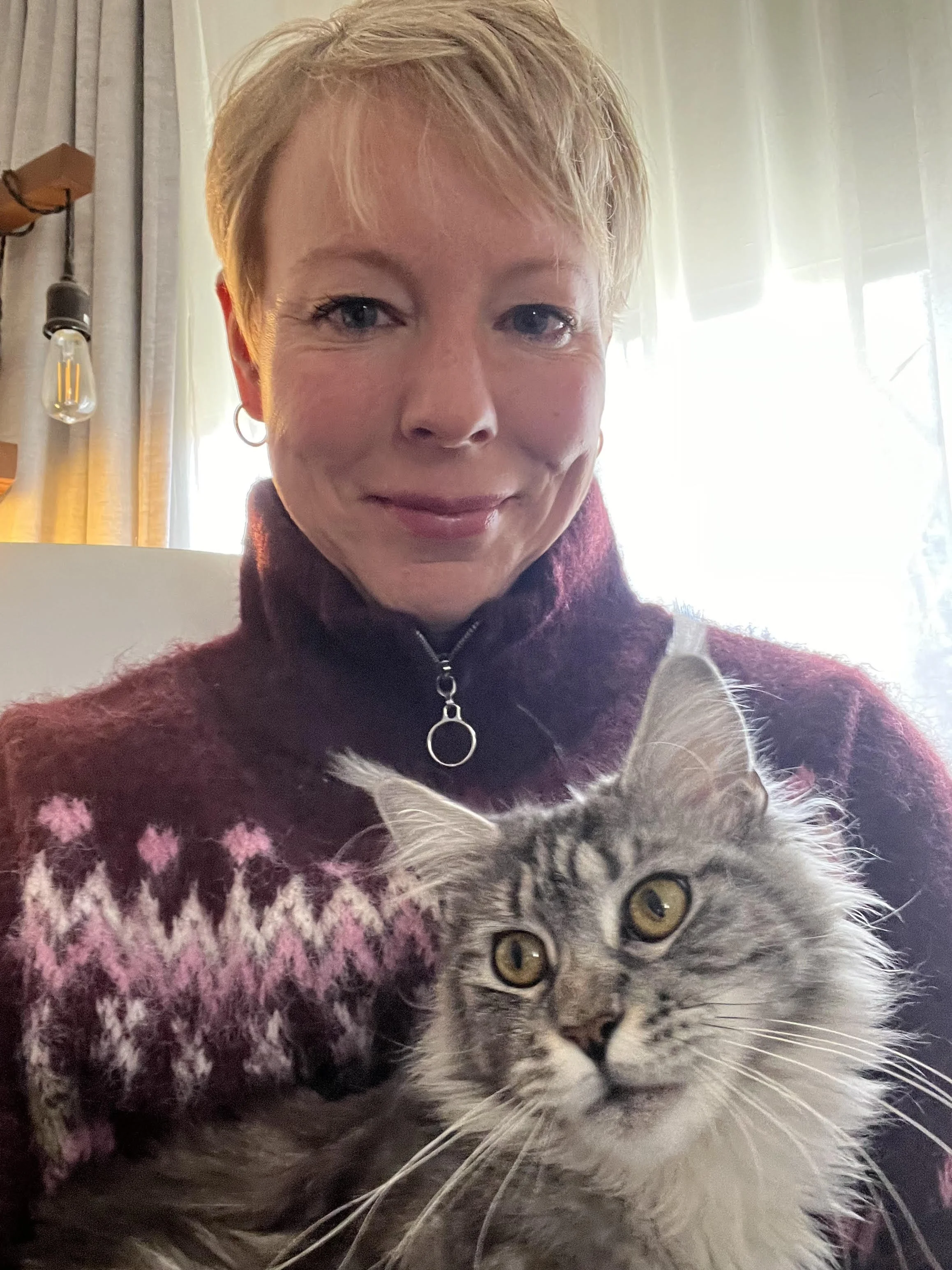 The author holding a black and silver tabby Maine Coon queen