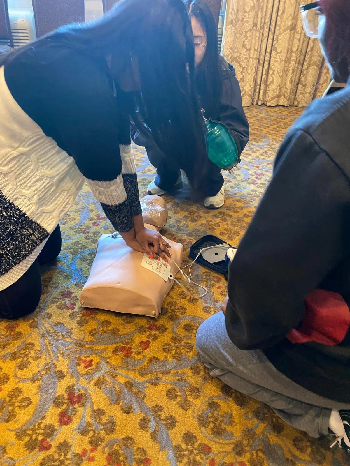 participants practicing cpr and aed in a first aid session