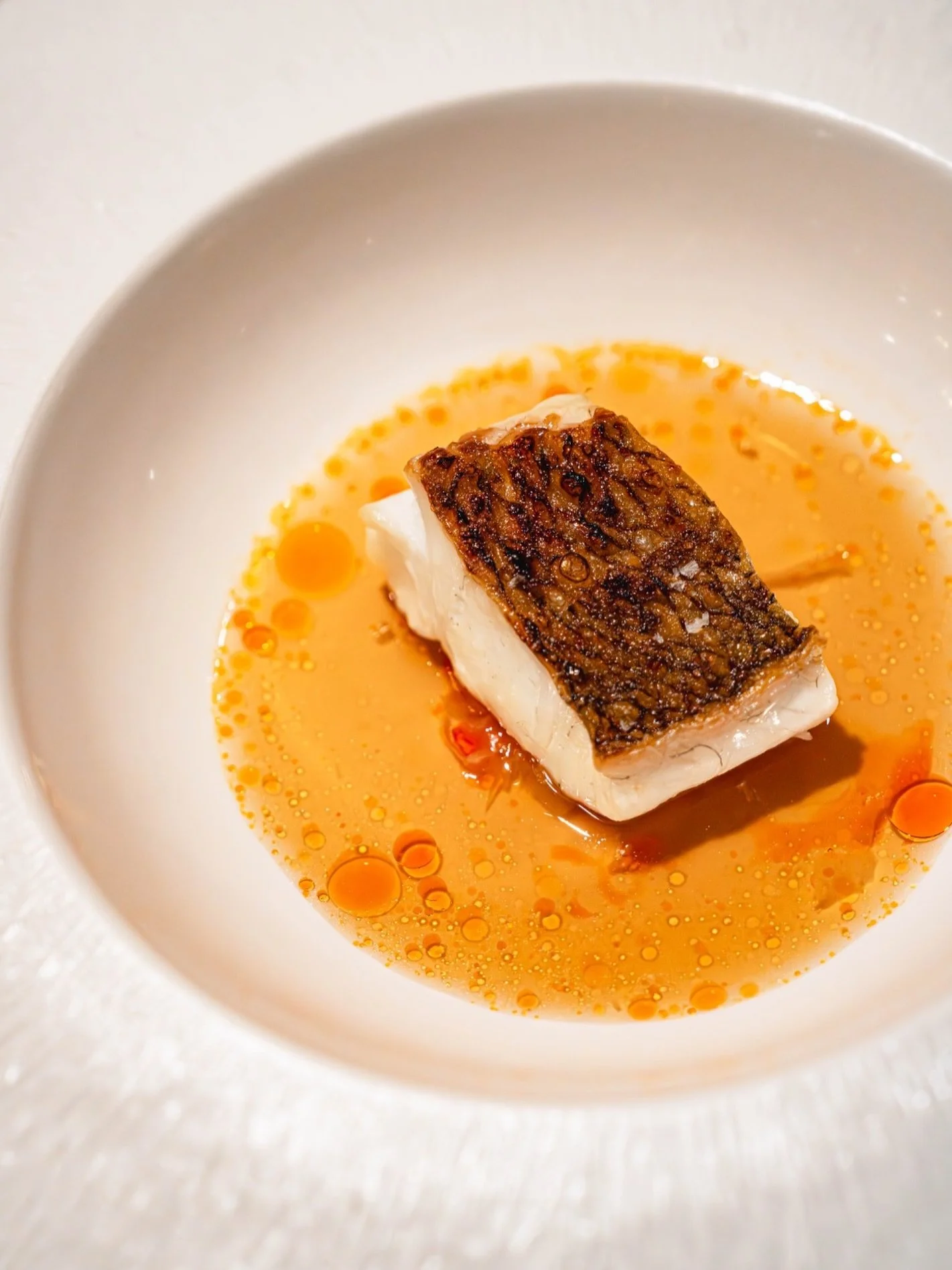 Abundance.

Grilled madai over binchotan, paired with sauerkraut and a mala consomm&eacute;.

Fish has long symbolized abundance in Chinese culture because the word for fish, &ldquo;yu&rdquo; (鱼), sounds like the word for surplus or abundance (余). It